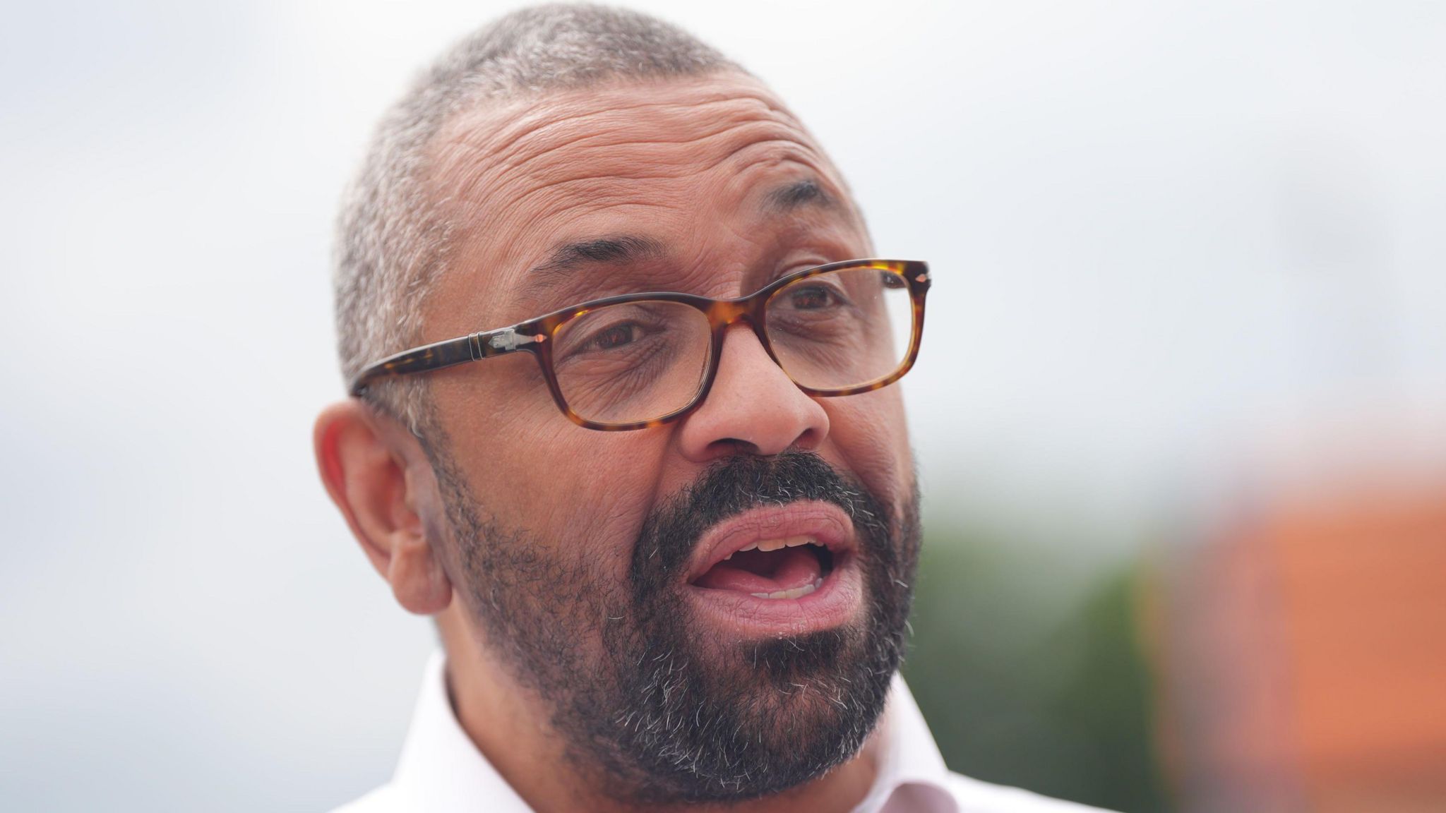 James Cleverly in a shirt and glasses