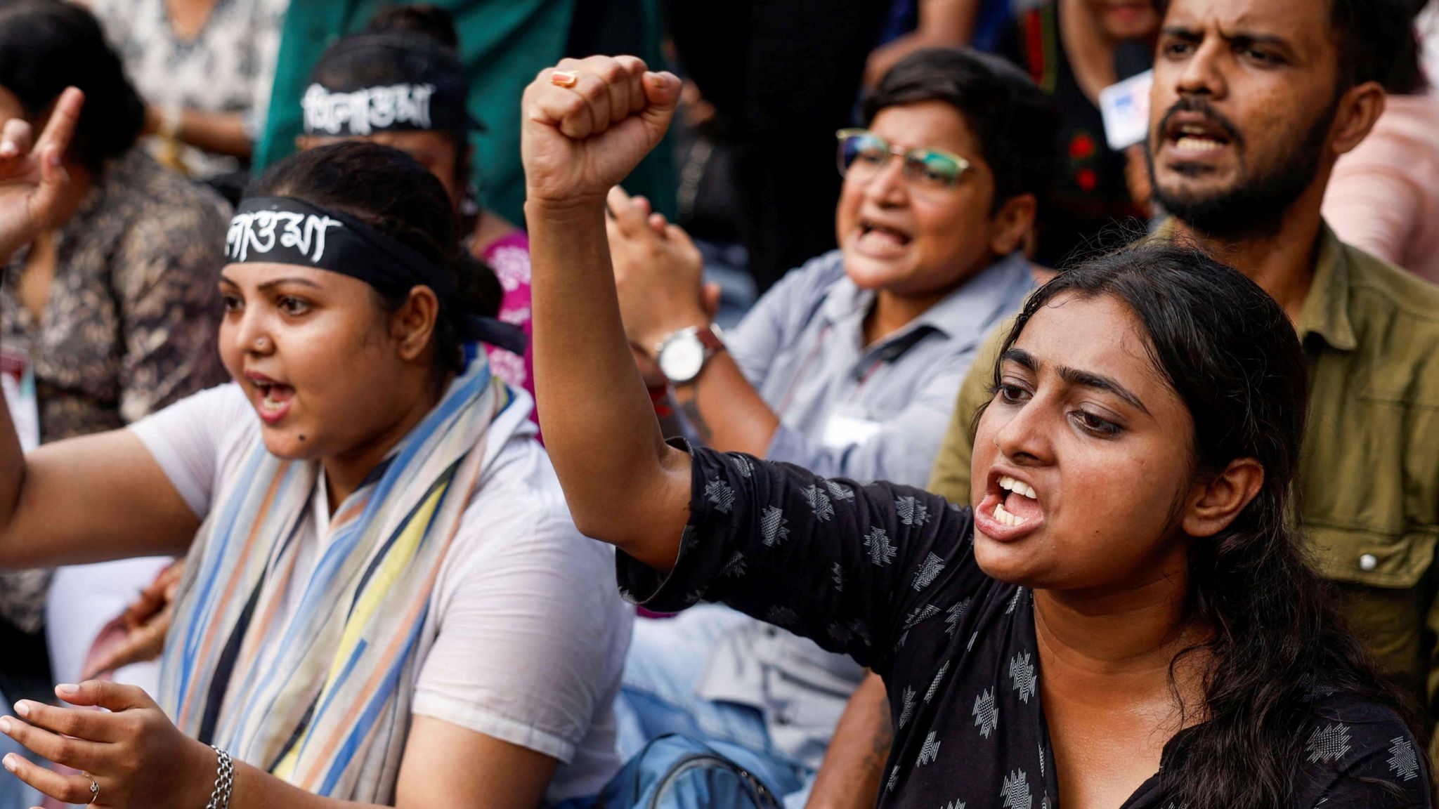 Medics sit and chant slogans as they attend a protest condemning the rape and murder of a trainee medic at a government-run hospital, in Kolkata, India, September 10, 2024.