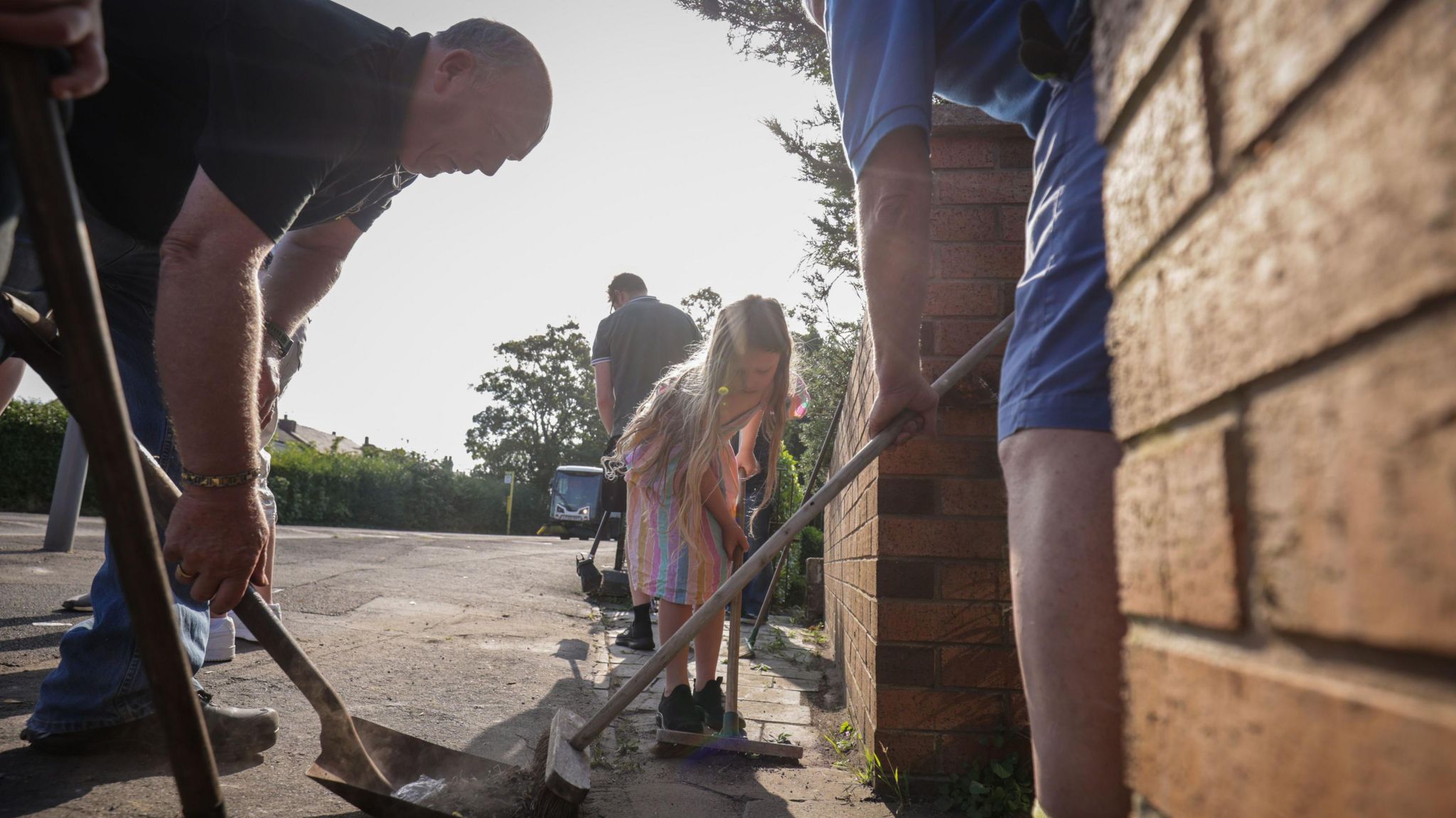 Volunteers sweep Sussex Road in Southport, Merseyside, after police officers suffered serious injuries when bricks, stones and bottles were thrown and cars were set alight during violent protests following a vigil for three girls killed in a knife attack at a Taylor Swift-themed holiday club on Monday.