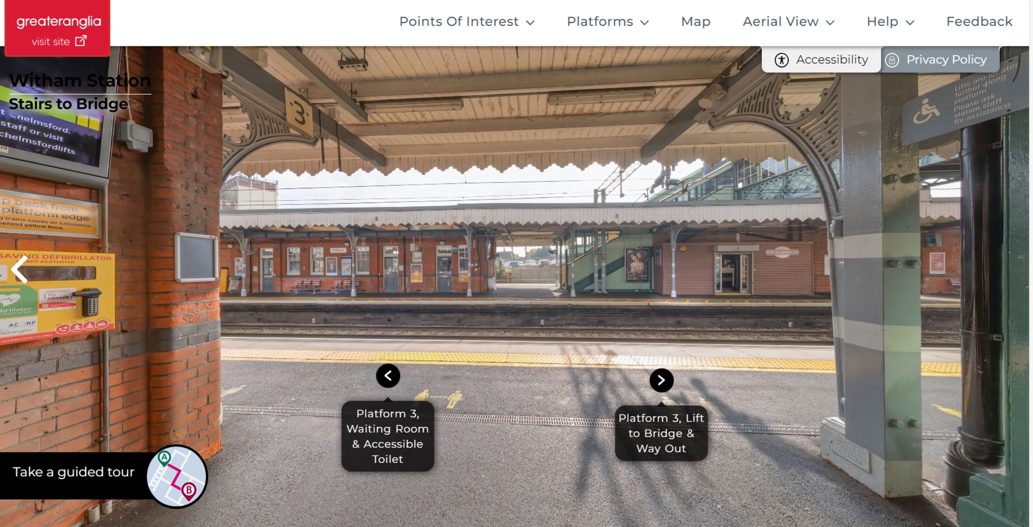 A screenshot of the open station platform at Witham railway station via the virtual tour. It shows the open platform with arrows indicating to the platform's lift and waiting room.