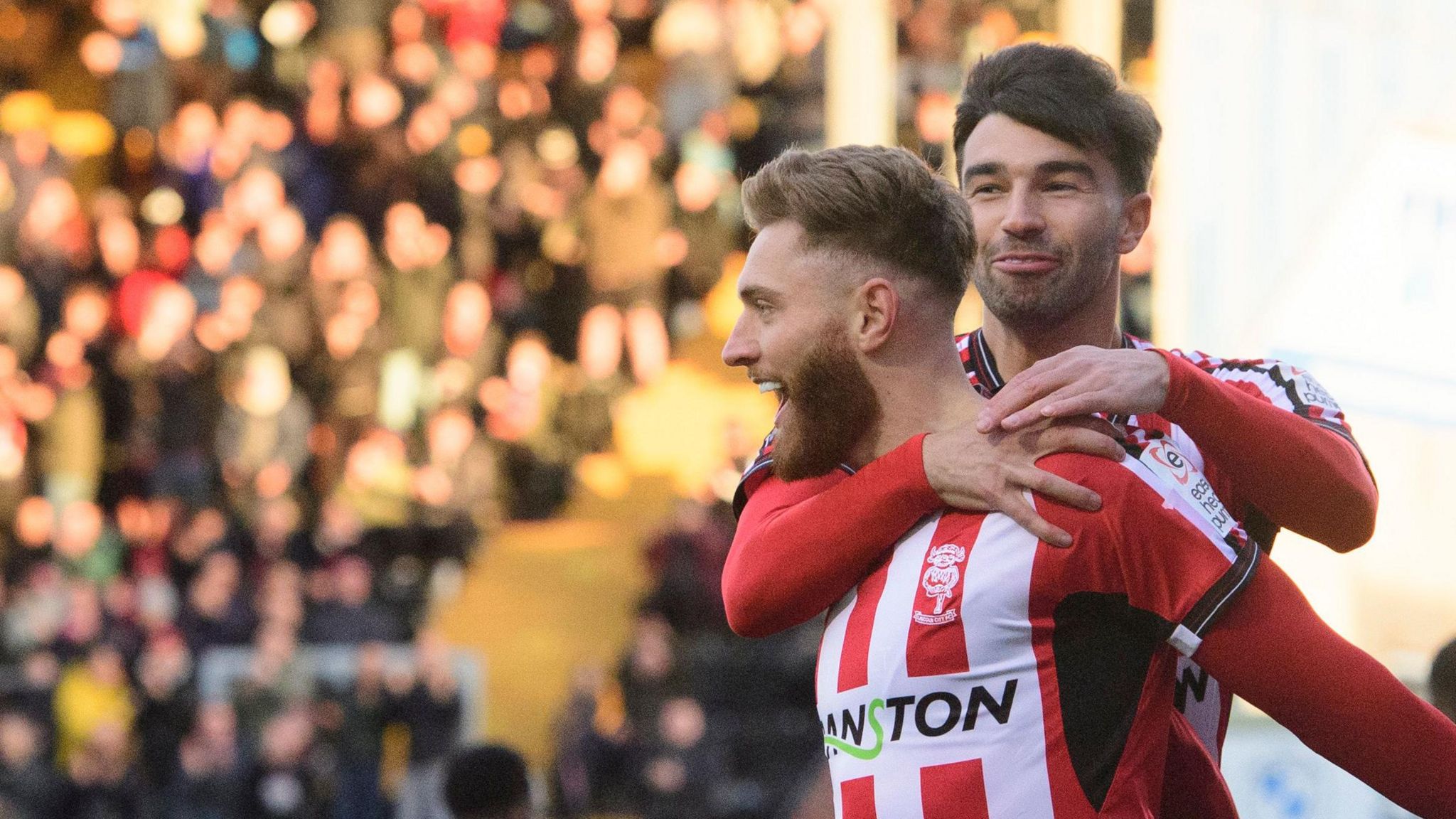 Lincoln City's Ted Bishop, left, celebrates scoring with team-mate Danny Mandroiu