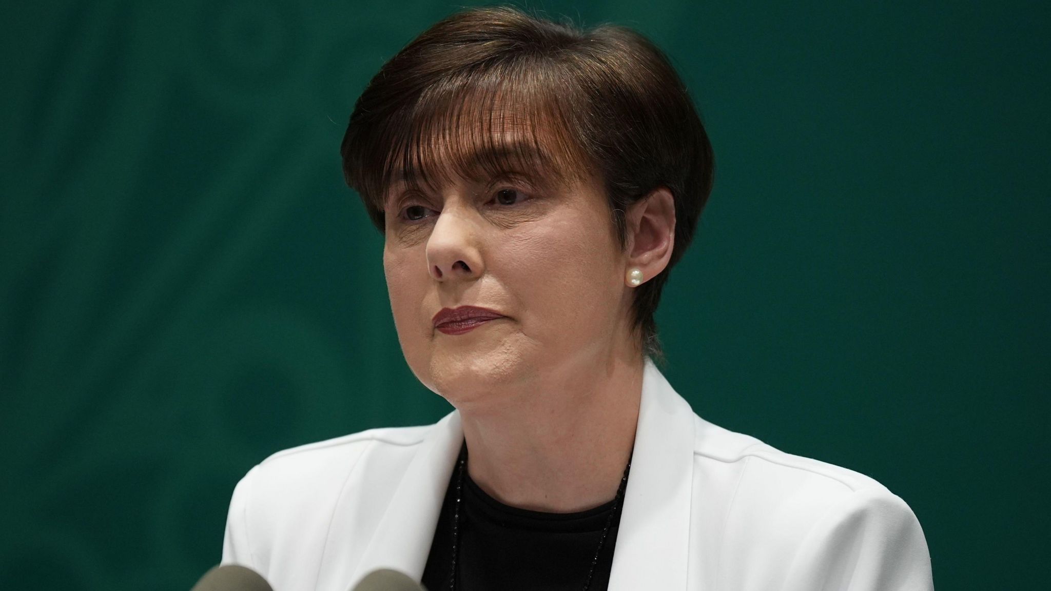 Irish Education Minister Norma Foley wearing a white jacket and a black top during a news conference