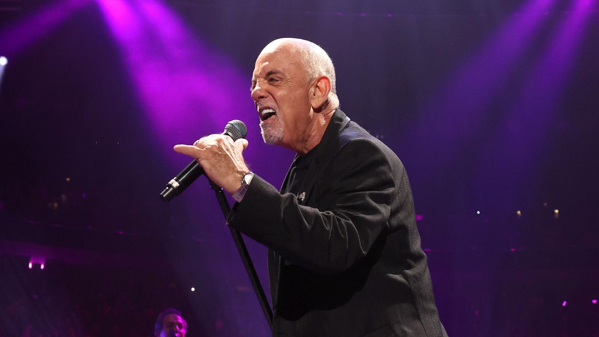 Billy Joel performing at his piano