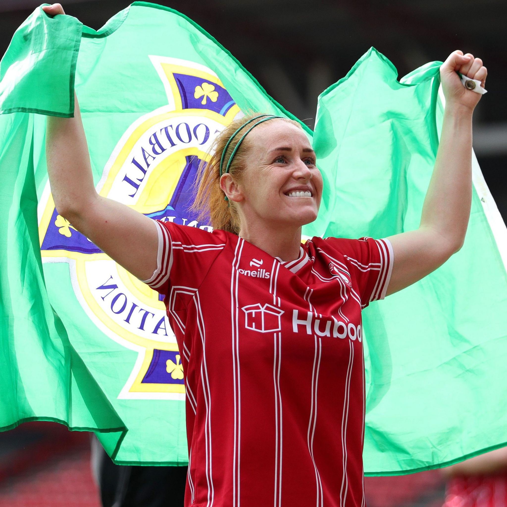 Rachel Furness celebrates in a Bristol City kit holding a Northern Ireland flag