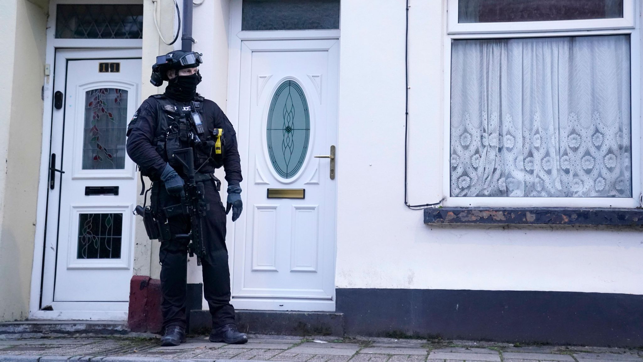 armed officer outside property on Wyndham Street
