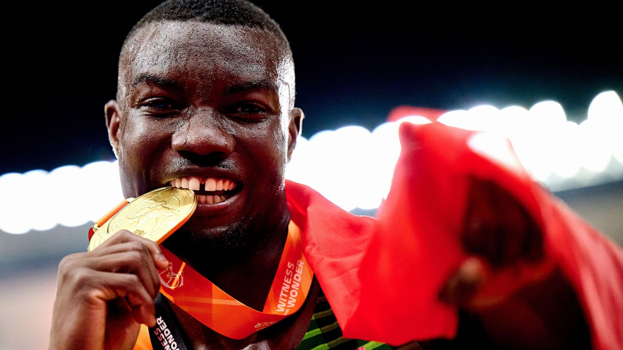 Hughes Fabrice Zango bites into a gold medal