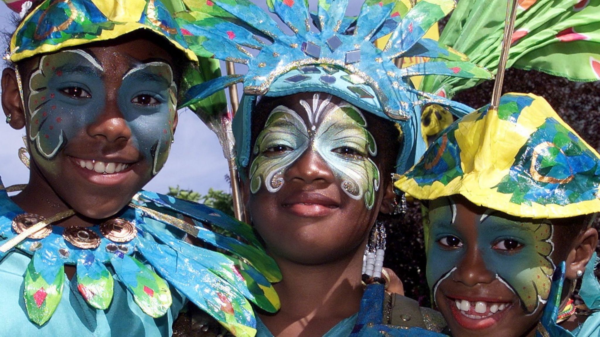 Three young people in Carnival costume