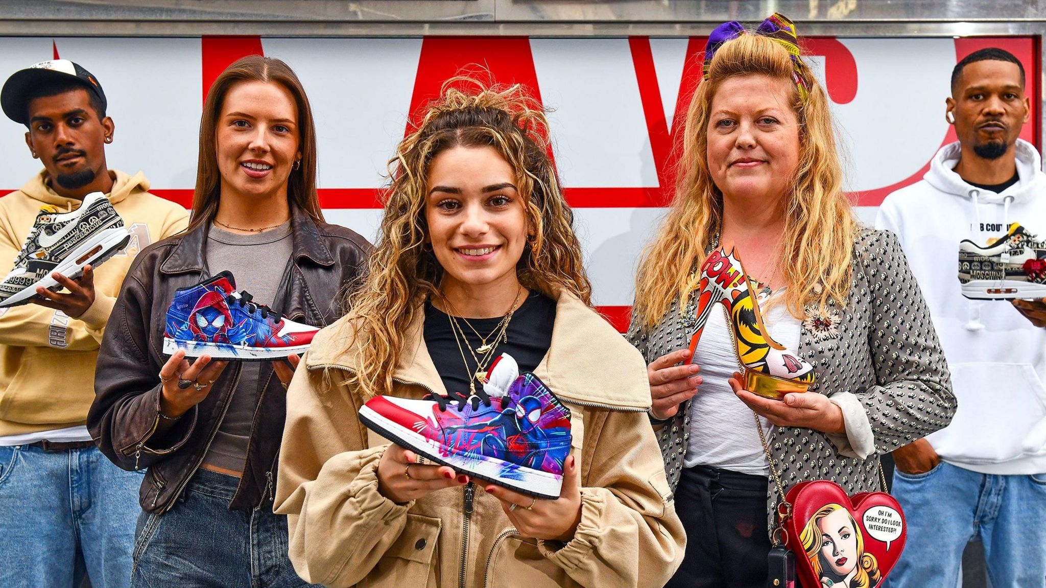 Five people holding shoes