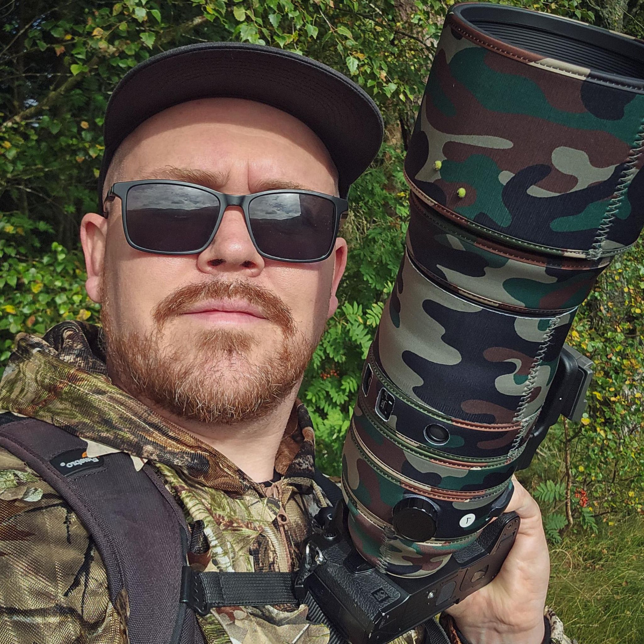 Jimmy Reid wears camouflage gear to take pictures of owls