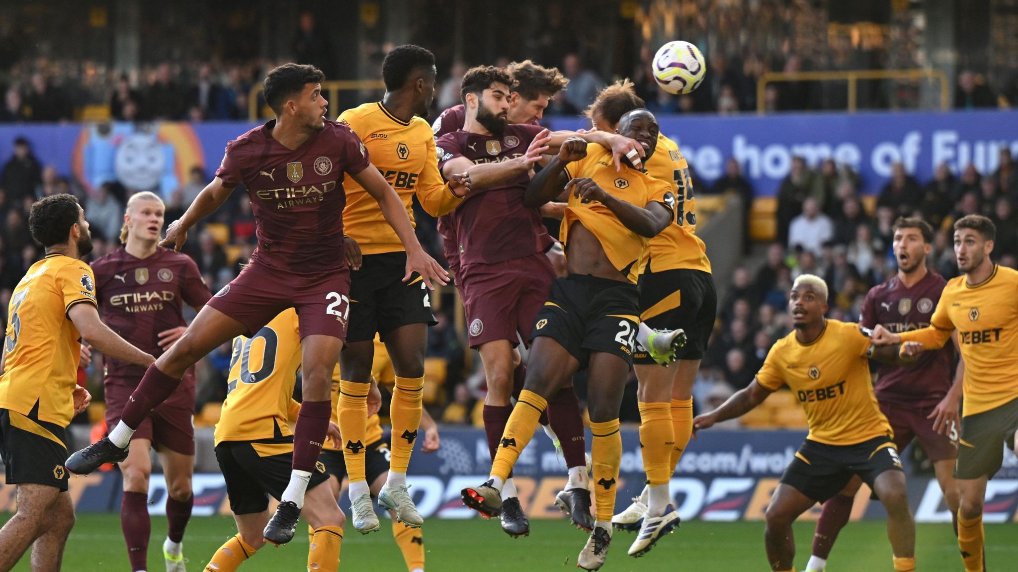 John Stones rises to meet Phil Foden's corner to head in Manchester City's stoppage-time winner at Wolves.