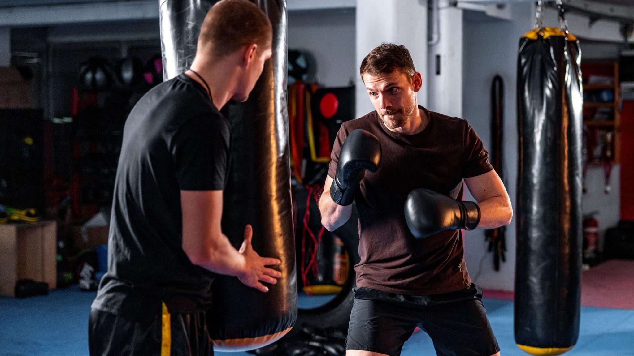 Two people training in a boxing gym