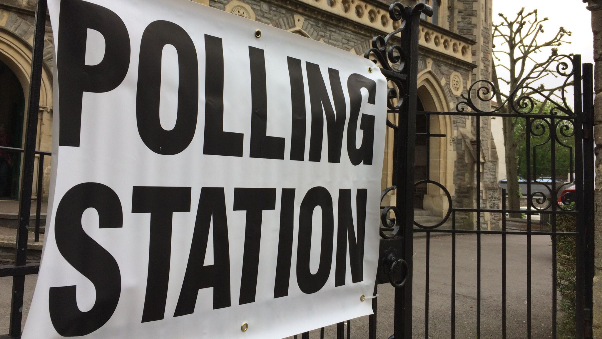 Polling station sign next to church in Bristol