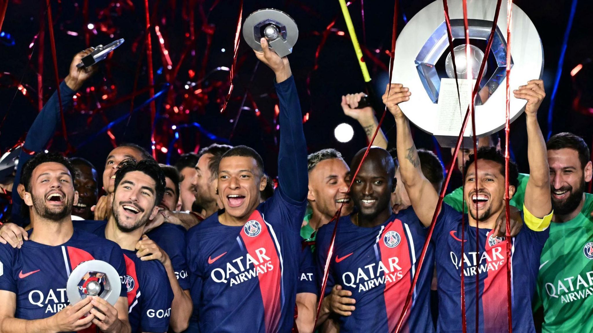 PSG players celebrate with the Ligue 1 trophy