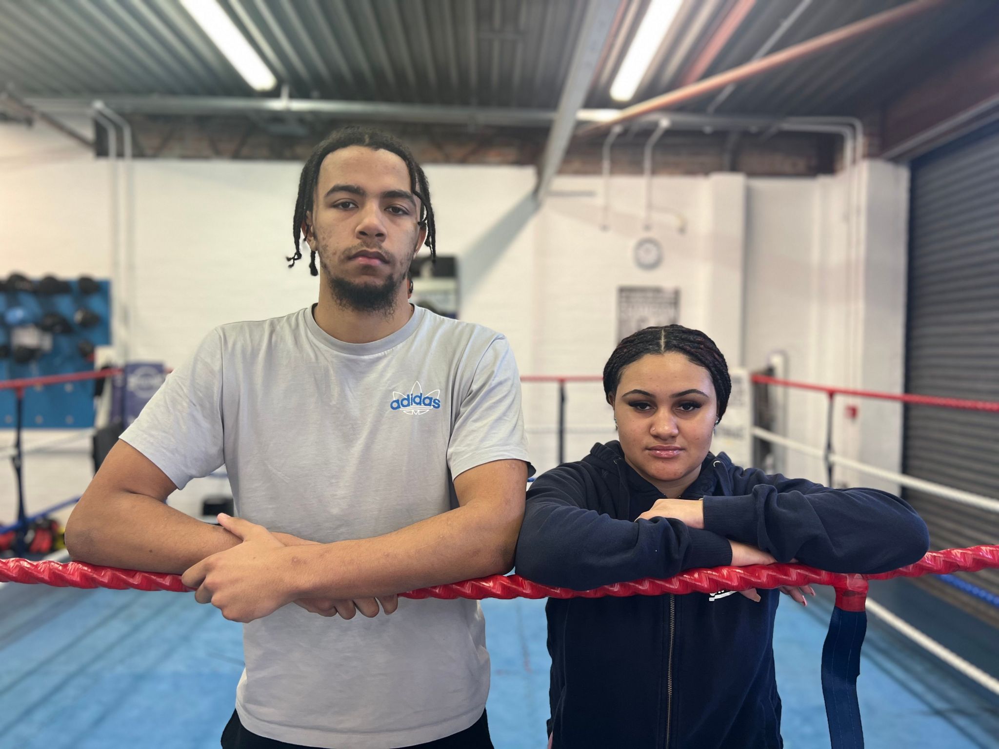 Marcel and Serena are standing next to each other in a boxing ring. 