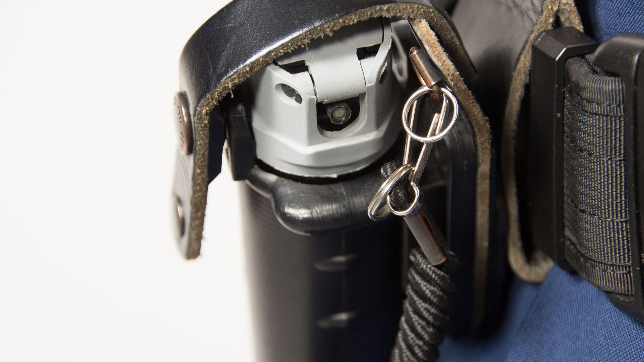 PAVA spray in a holster on a police officer's belt