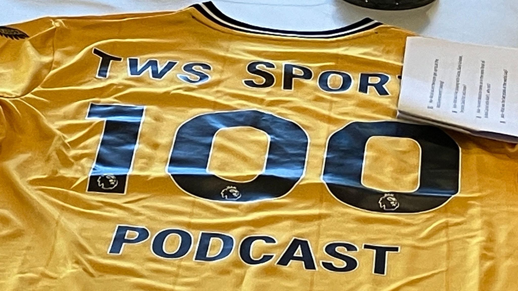 Tshirt with TWS Sport 100 podcast in writing