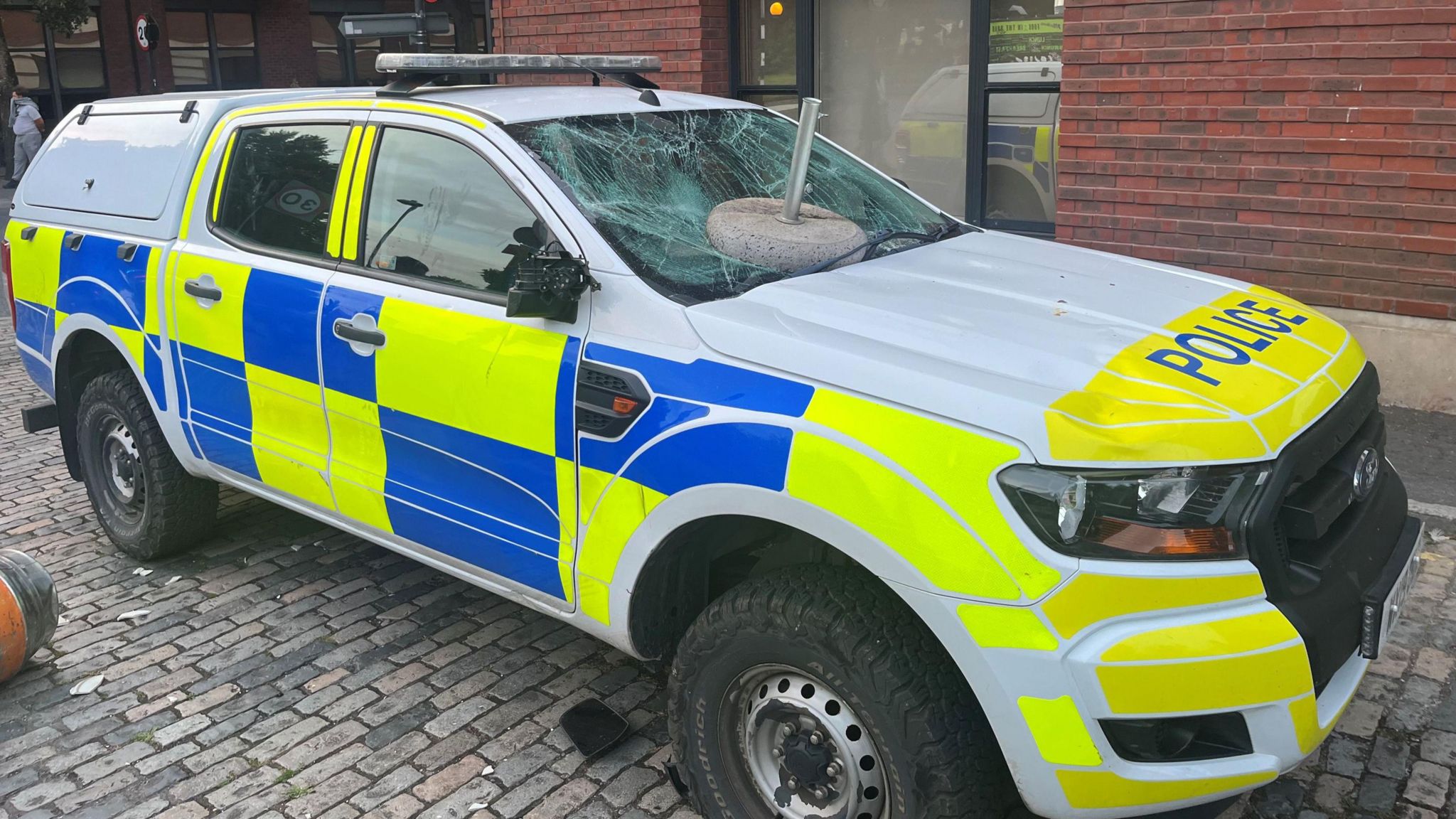 A police van with a smashed windscreen.