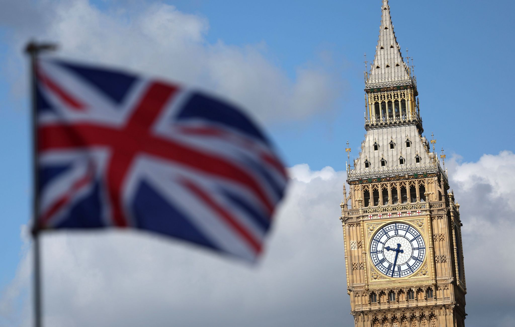 A union jack flies with Big Ben in the background