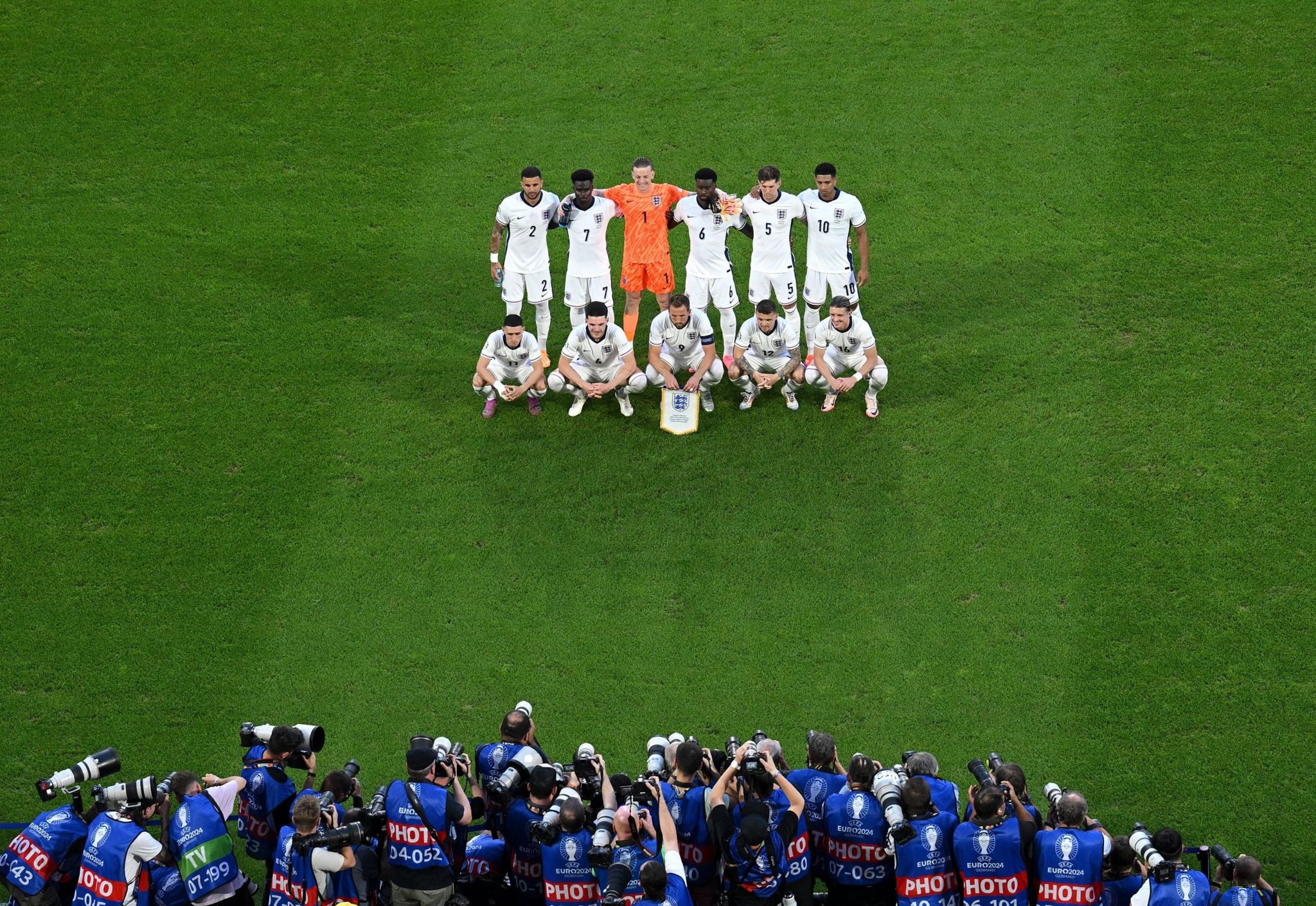 The England team line up in front of photographers before the group game against Slovenia