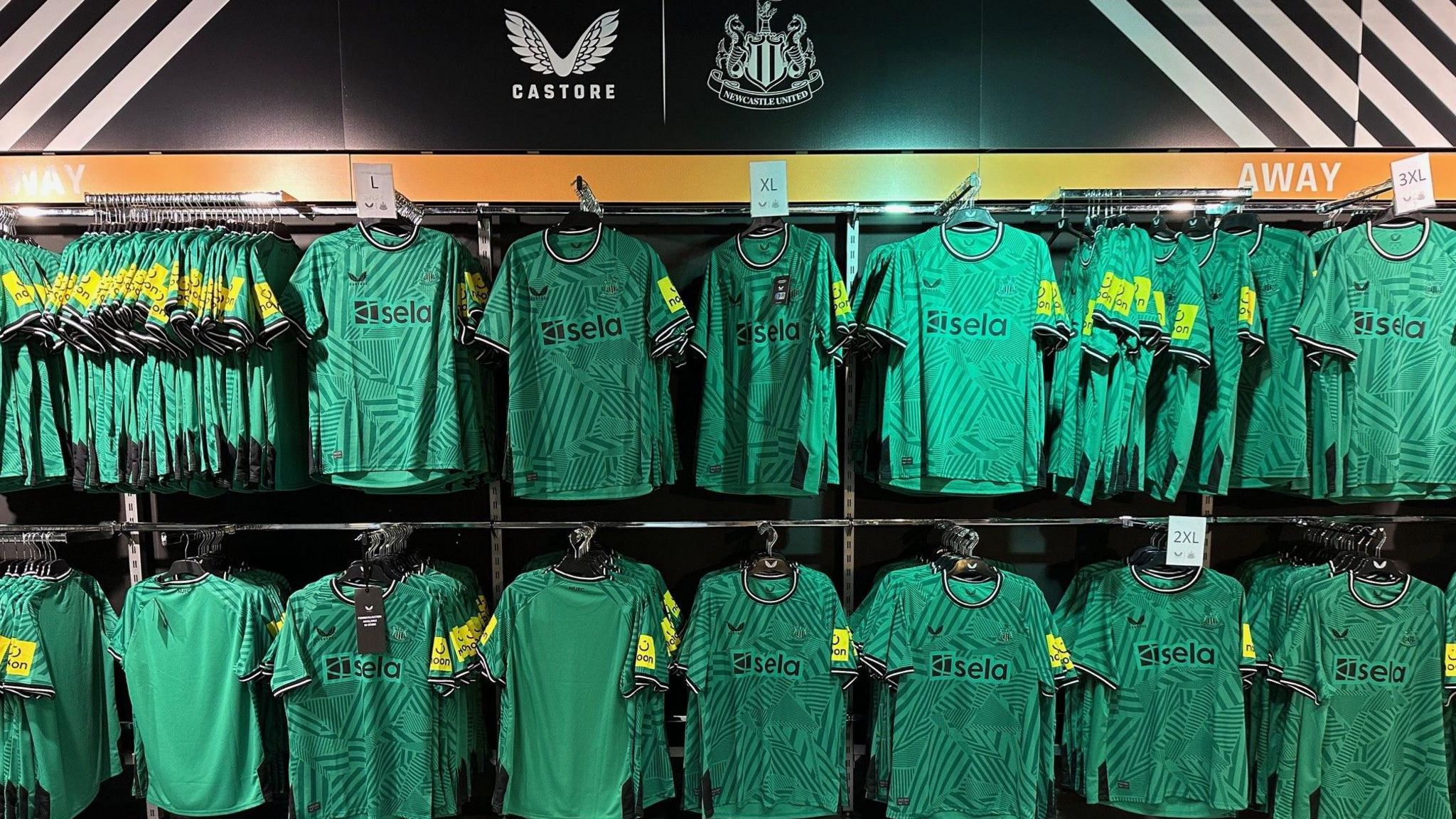 Racks of green Newcastle shirts
