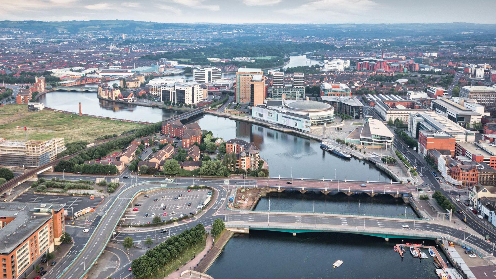 Aerial view of Belfast city showing the Waterfront and surrounding buildings close to three bridges over the Lagan river 