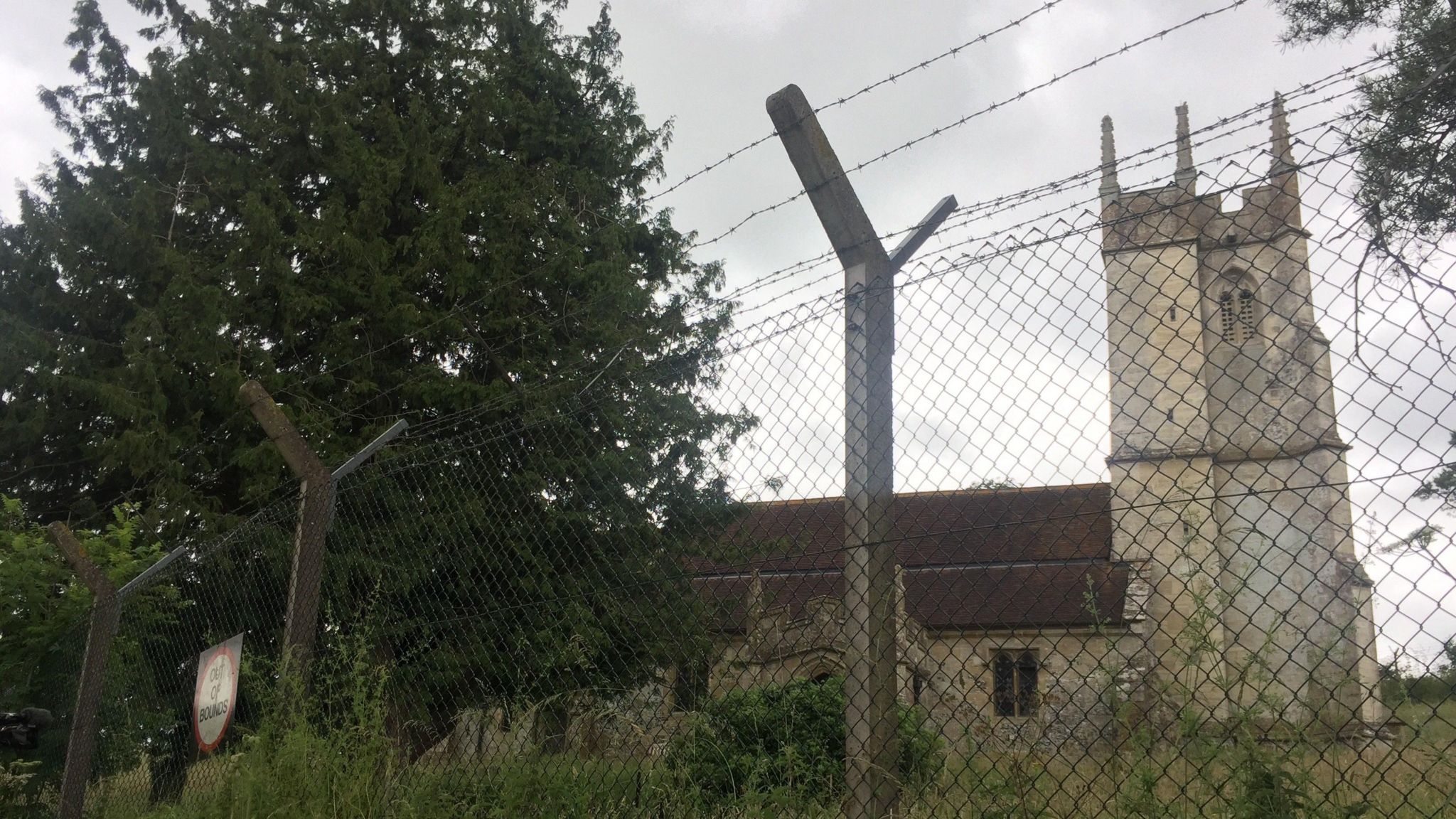 Imber's church, St Giles, behind high barbed fences with an out of bounds sign