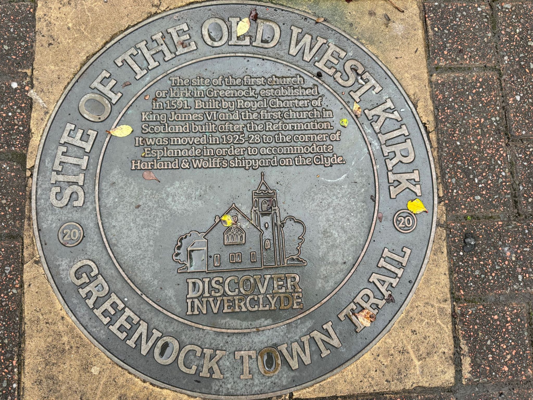 Plaque on the grounds of the original site of the church which reads: "Site of the Old West Kirk. The site of the first church or kirk in Greenock established in 1591. Built by Royal Charter of King James VI and the first church in Scotland built after the Reformation. It was moved in 1925-28 to the corner of Esplanade in order to accommodate Harland & Wolff's shipyard on the Clyde@