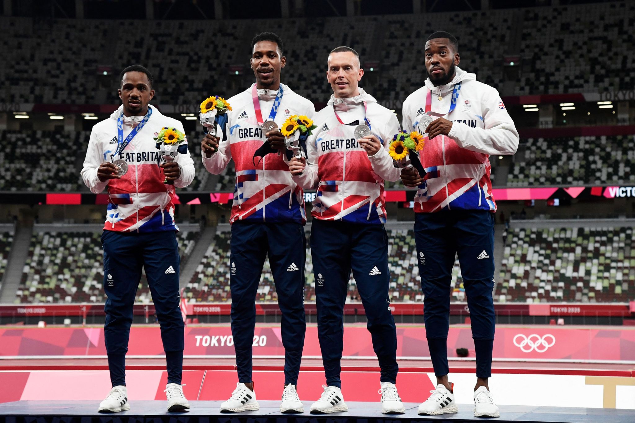 The 4x100m relay team stood on the podium with their silver medals 