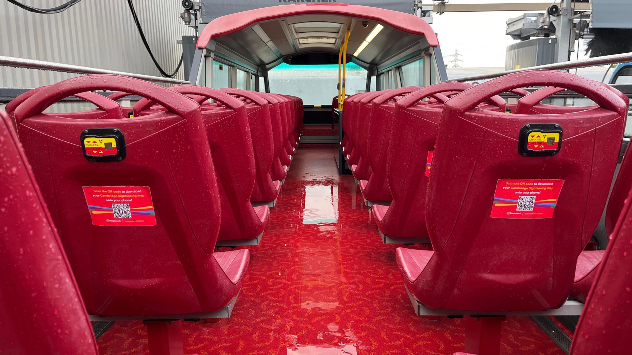 An open-top bus going through the new bus wash