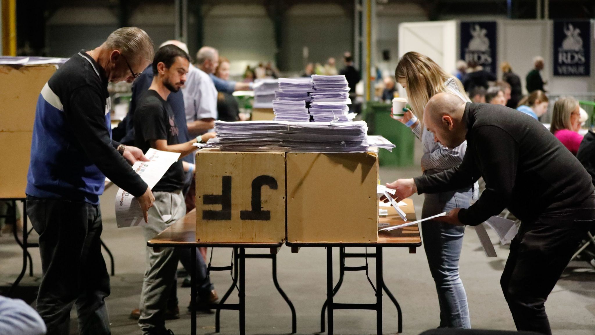 People tallying votes at the Royal Dublin Society during the count for the European elections