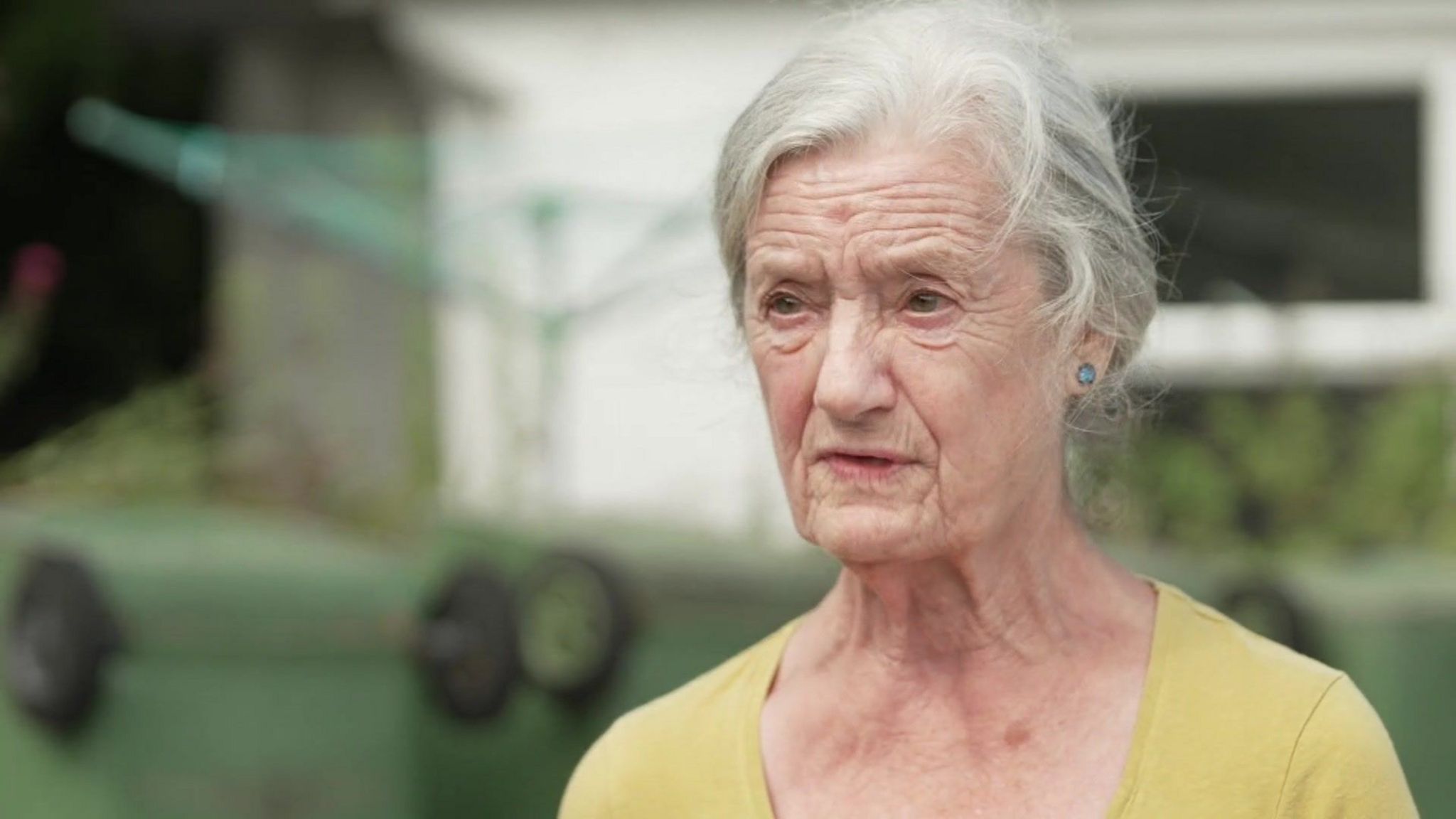 Resident Carol Doyle, seen with her head and shoulders to the right of the photograph, wearing a yellow top 