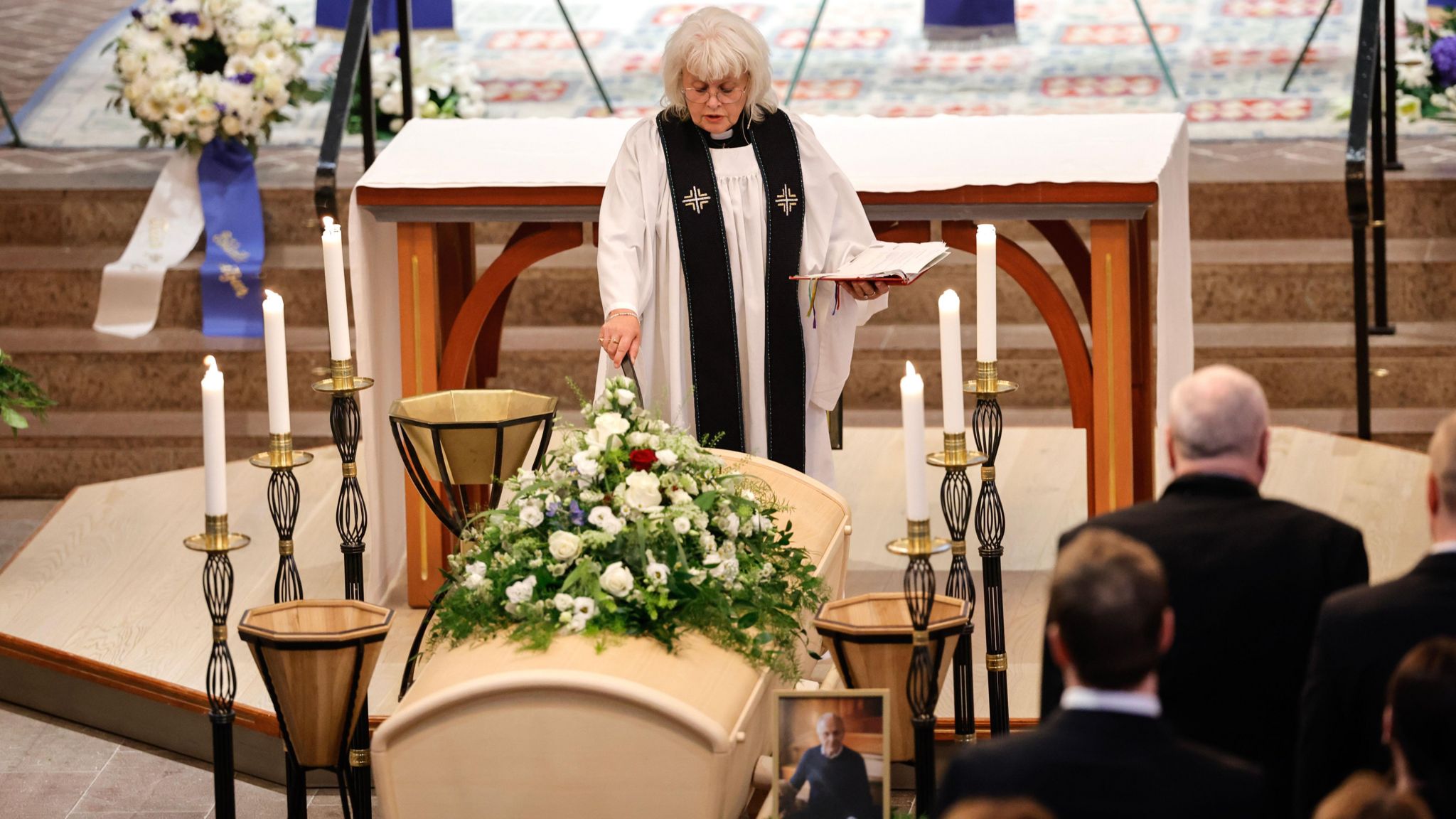 A priest stands next to the coffin of Sven-Goran Eriksson