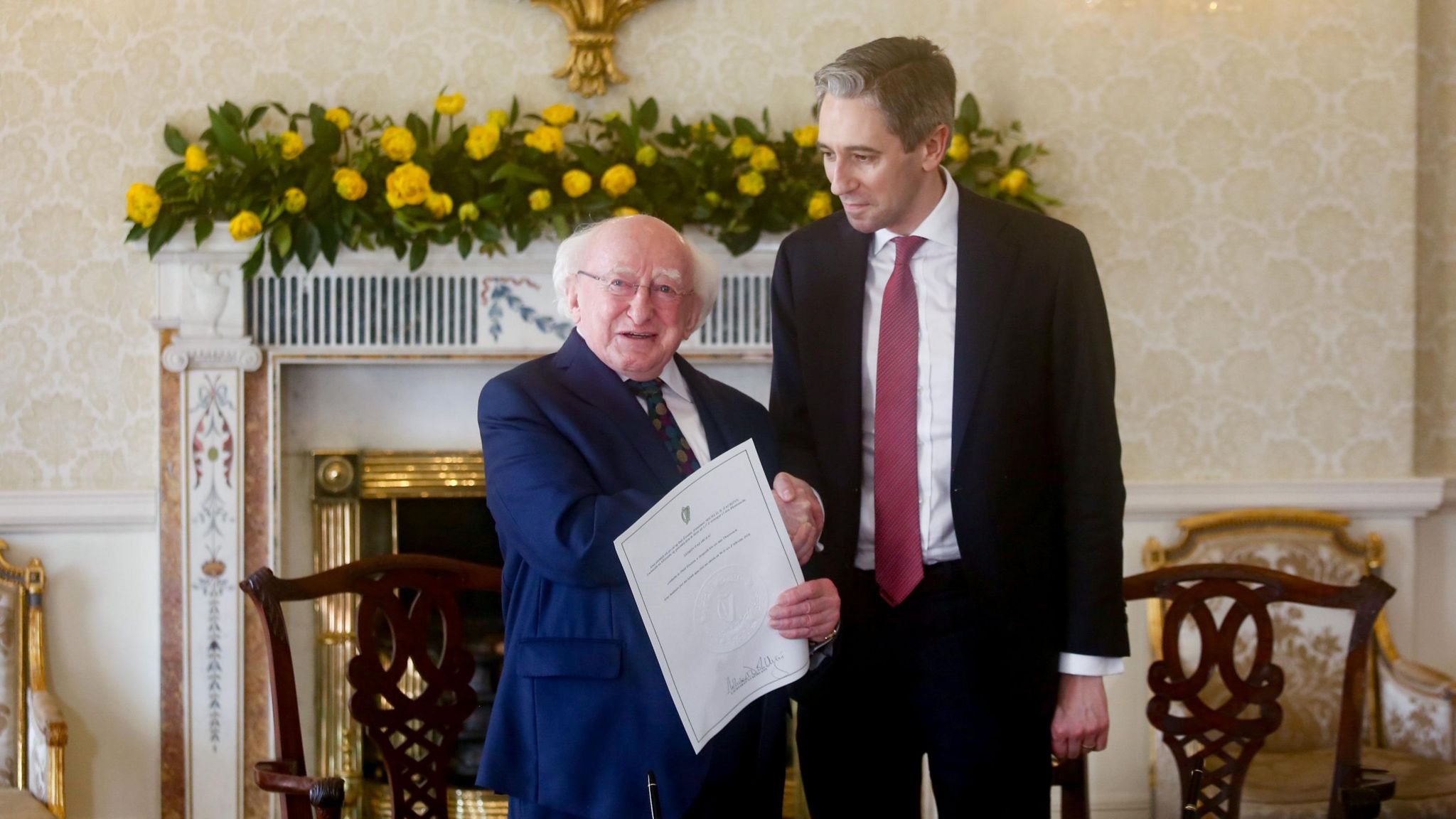 President Michael Higgins shakes hands with newly elected Taoiseach Simon Harris
