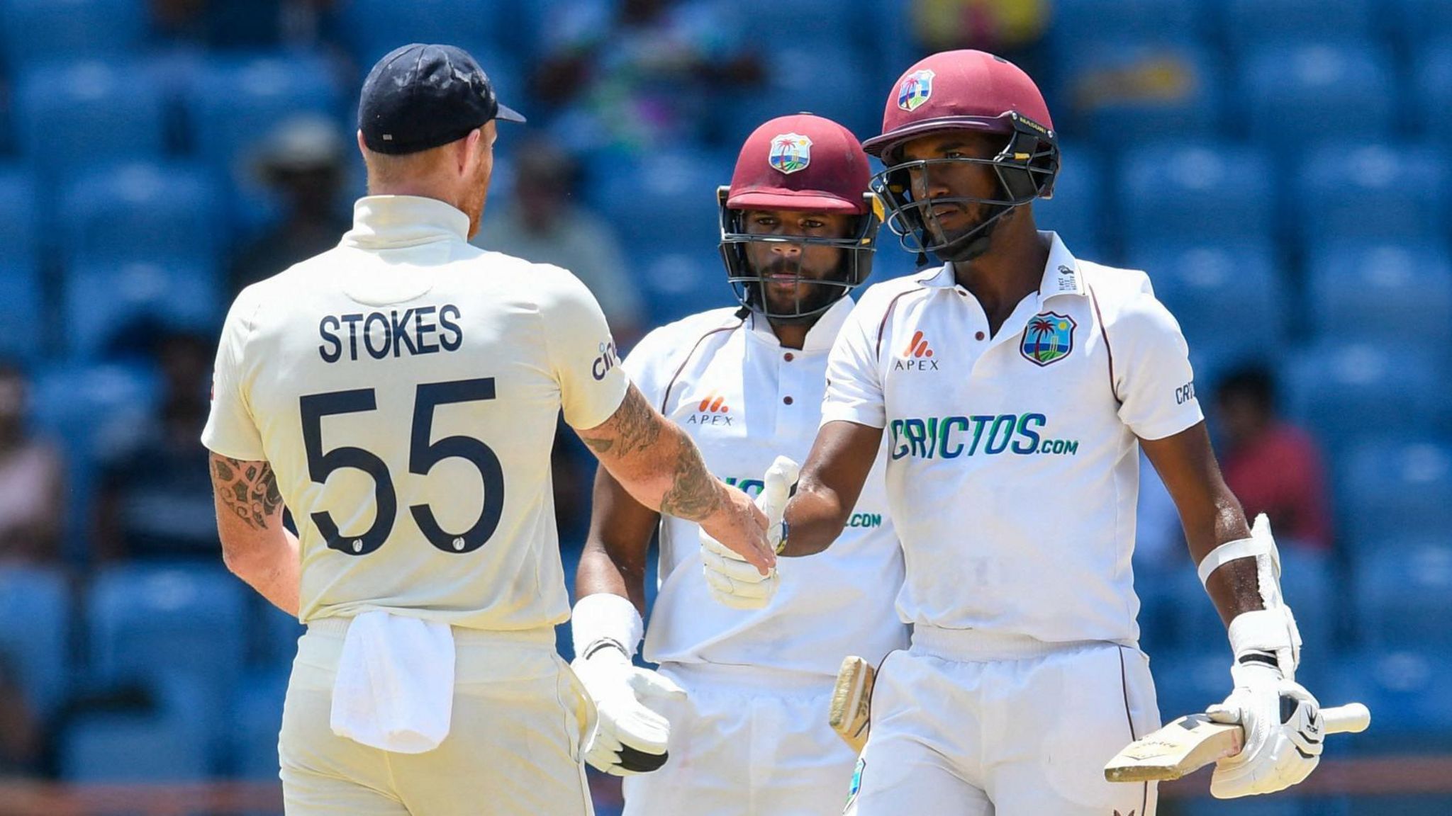 England's Ben Stokes shakes hands with West Indies captain Kraigg Brathwaite, as John Campbell looks on