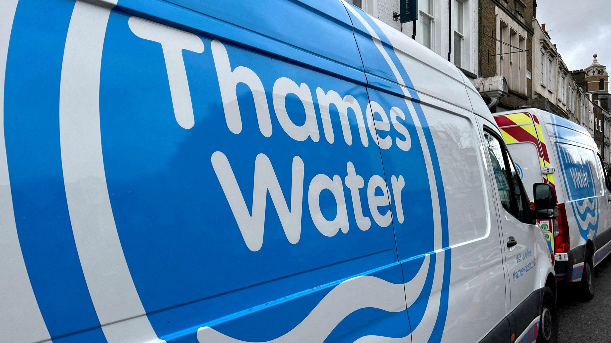 Thames Water vans parked on a road as repair and maintenance work takes place in London