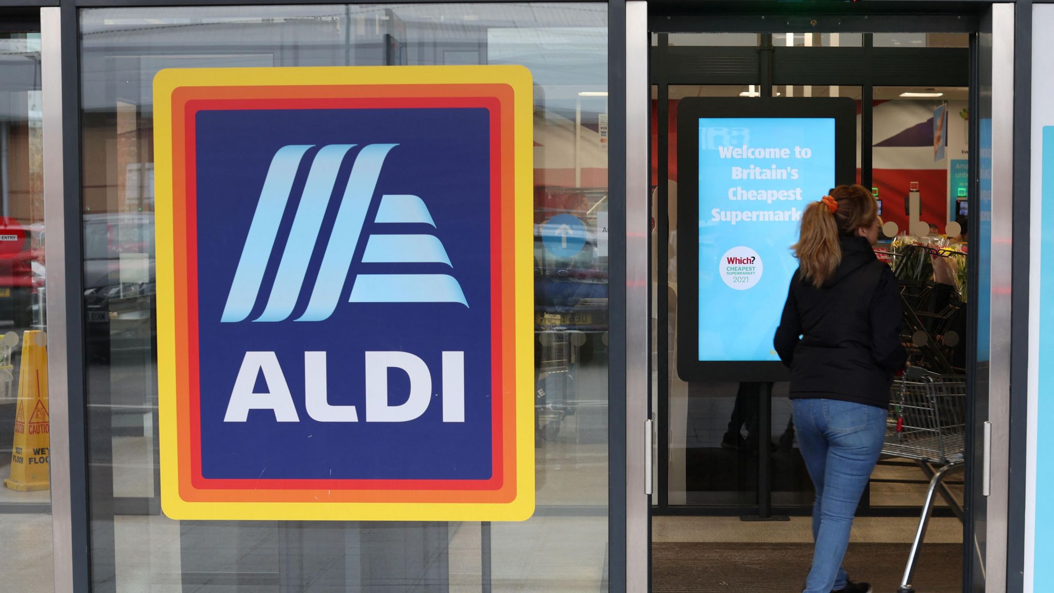 A shopper walks inside an Aldi supermarket