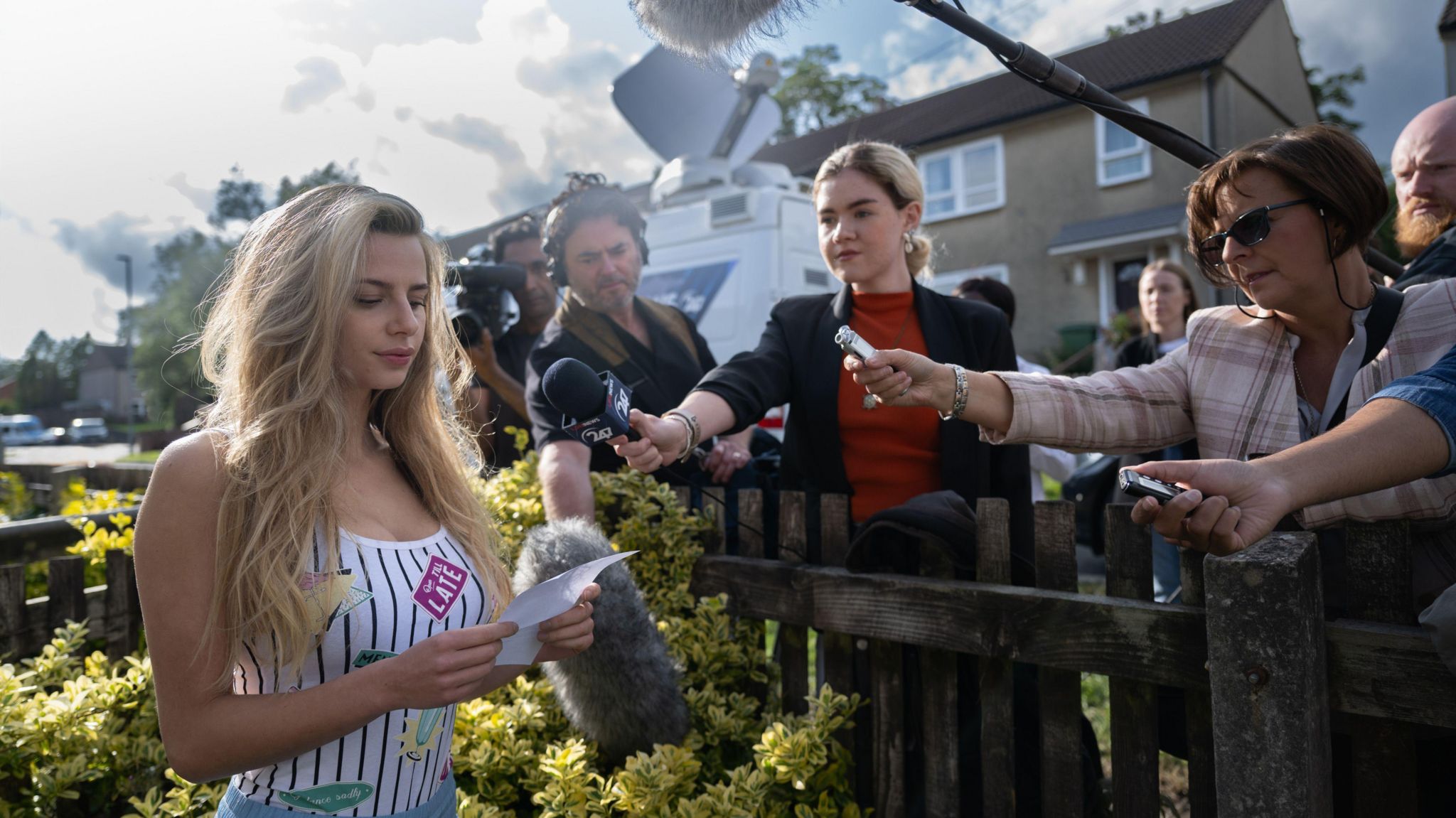 Actor Nadia Parkes as Chloe Ayling surrounded by reporters 