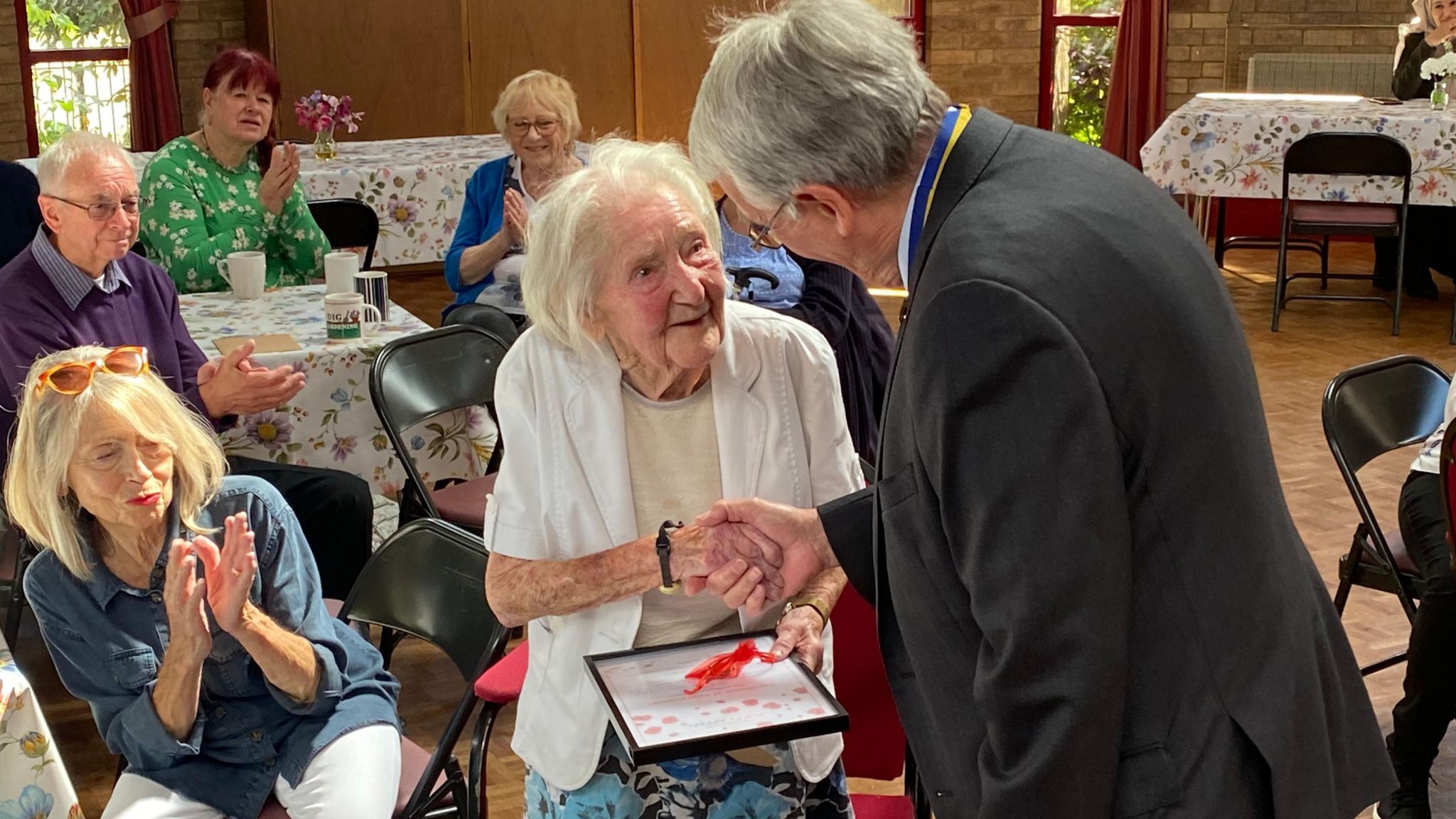 Roger Herriot presenting Joan Tanton with a long term service award