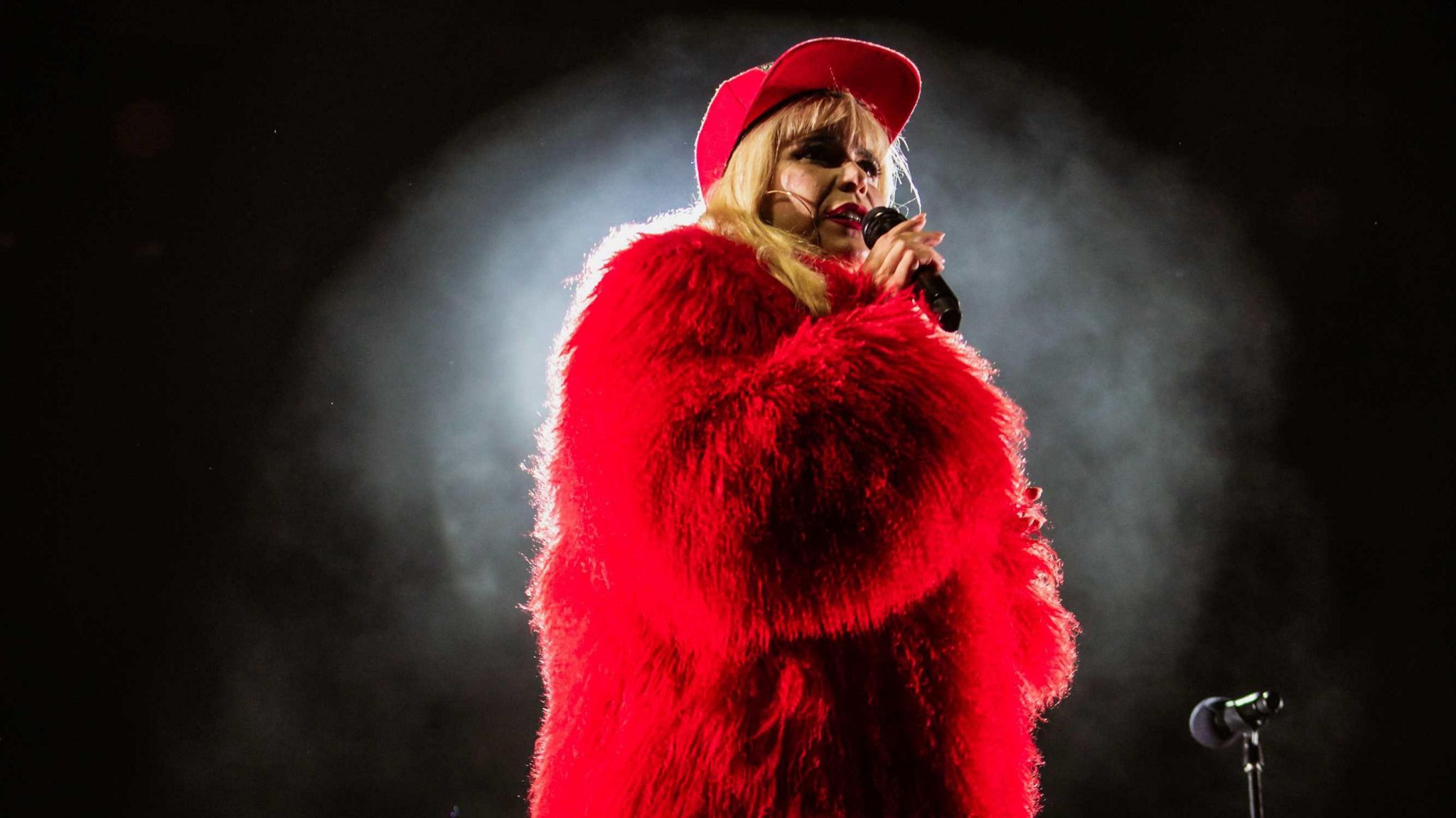 Paloma Faith wearing a red two piece with a red faux fur coat