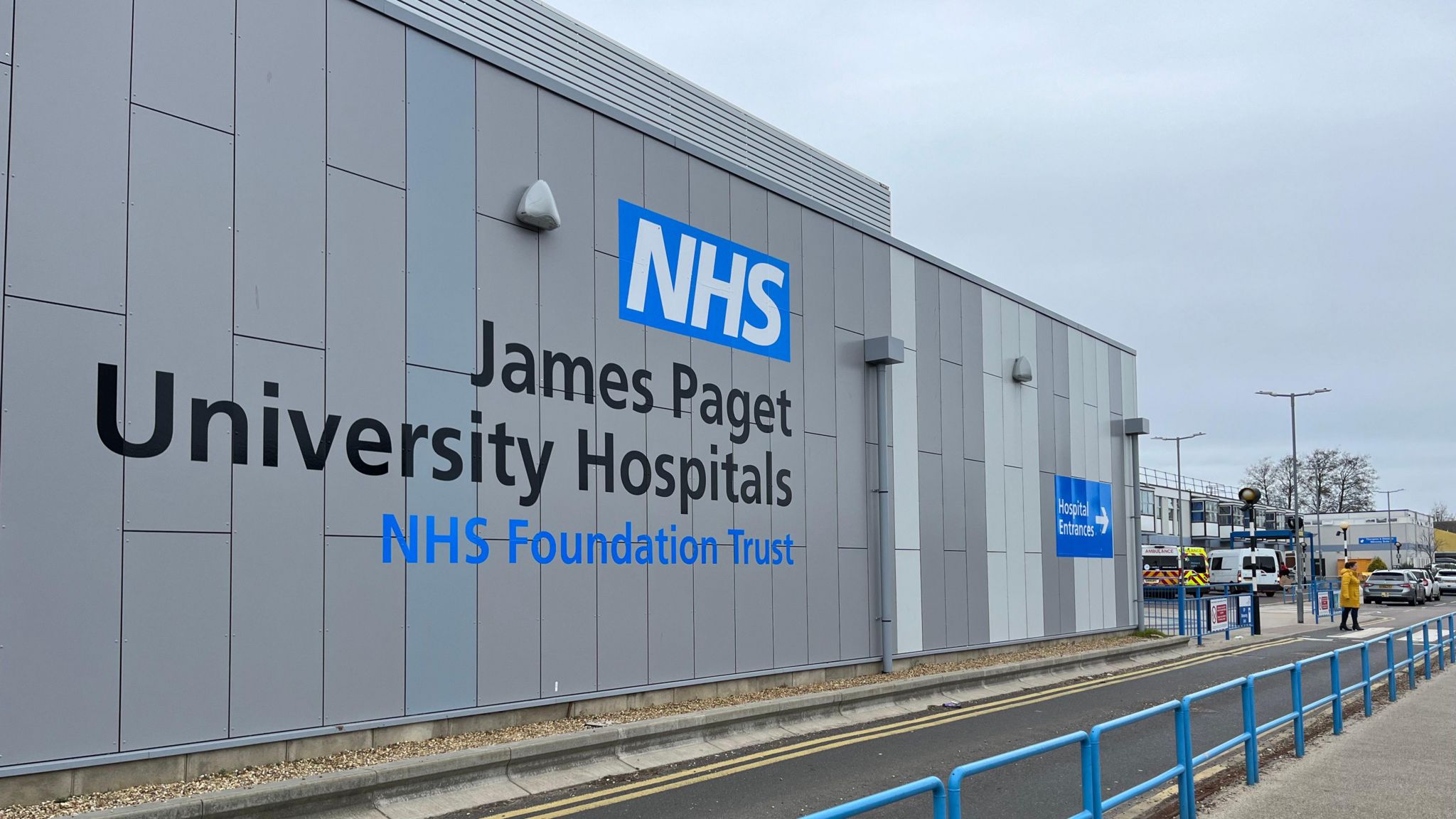 A picture of a wall of the James Paget Hospital in Gorleston, with its name painted on it.