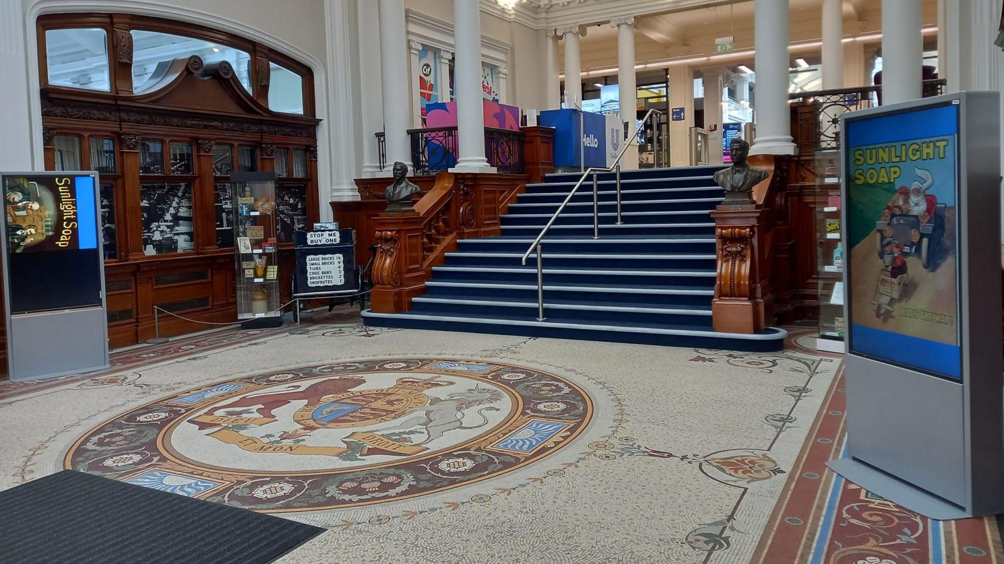 Mosaic floor with coast of arms in Lever House, surrounded by busts of Lever Brothers and old posters and memorabilia of their soap manufactures