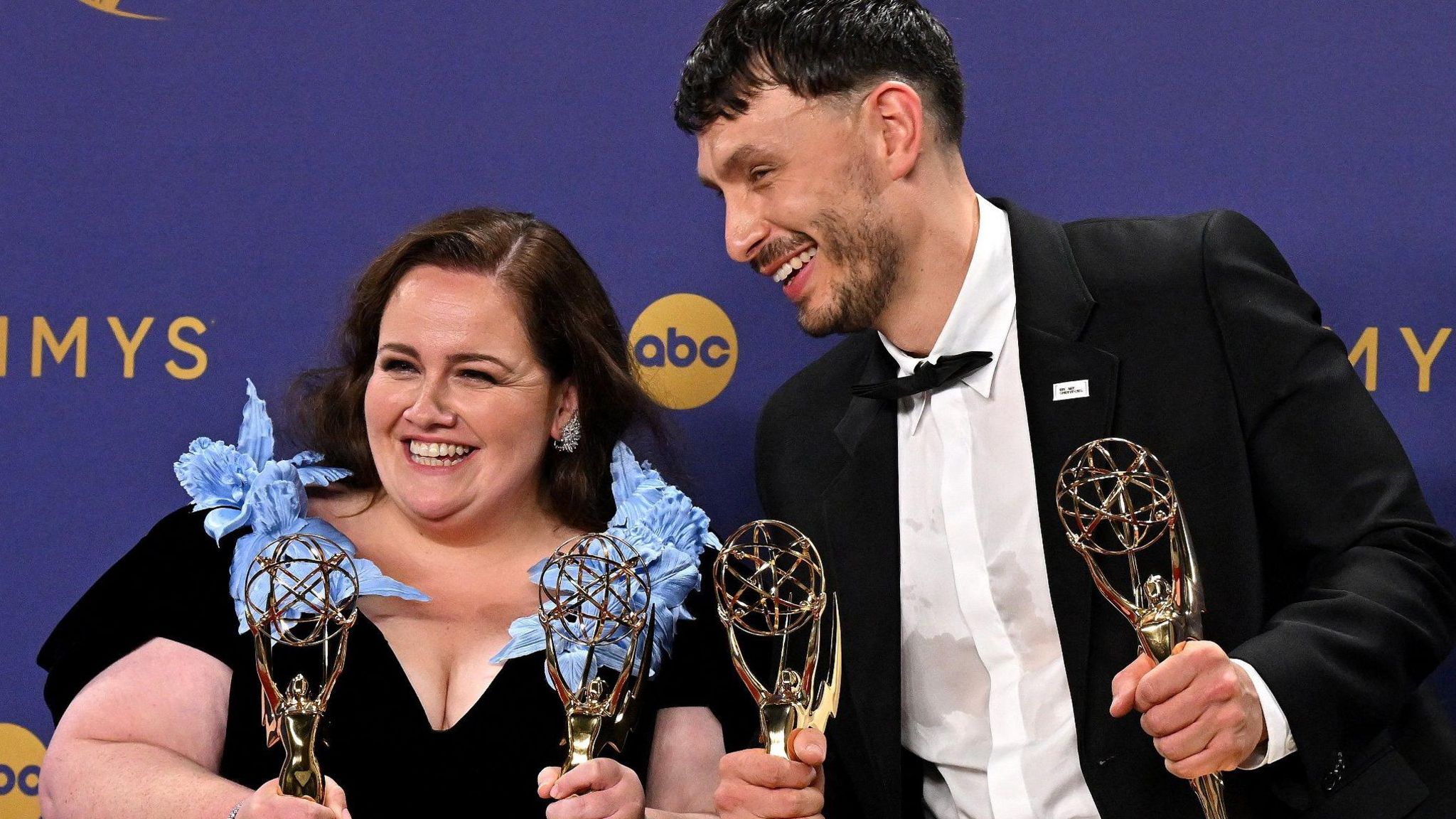 Jessica Gunning and Richard Gadd smiling and holding their four Emmy Awards