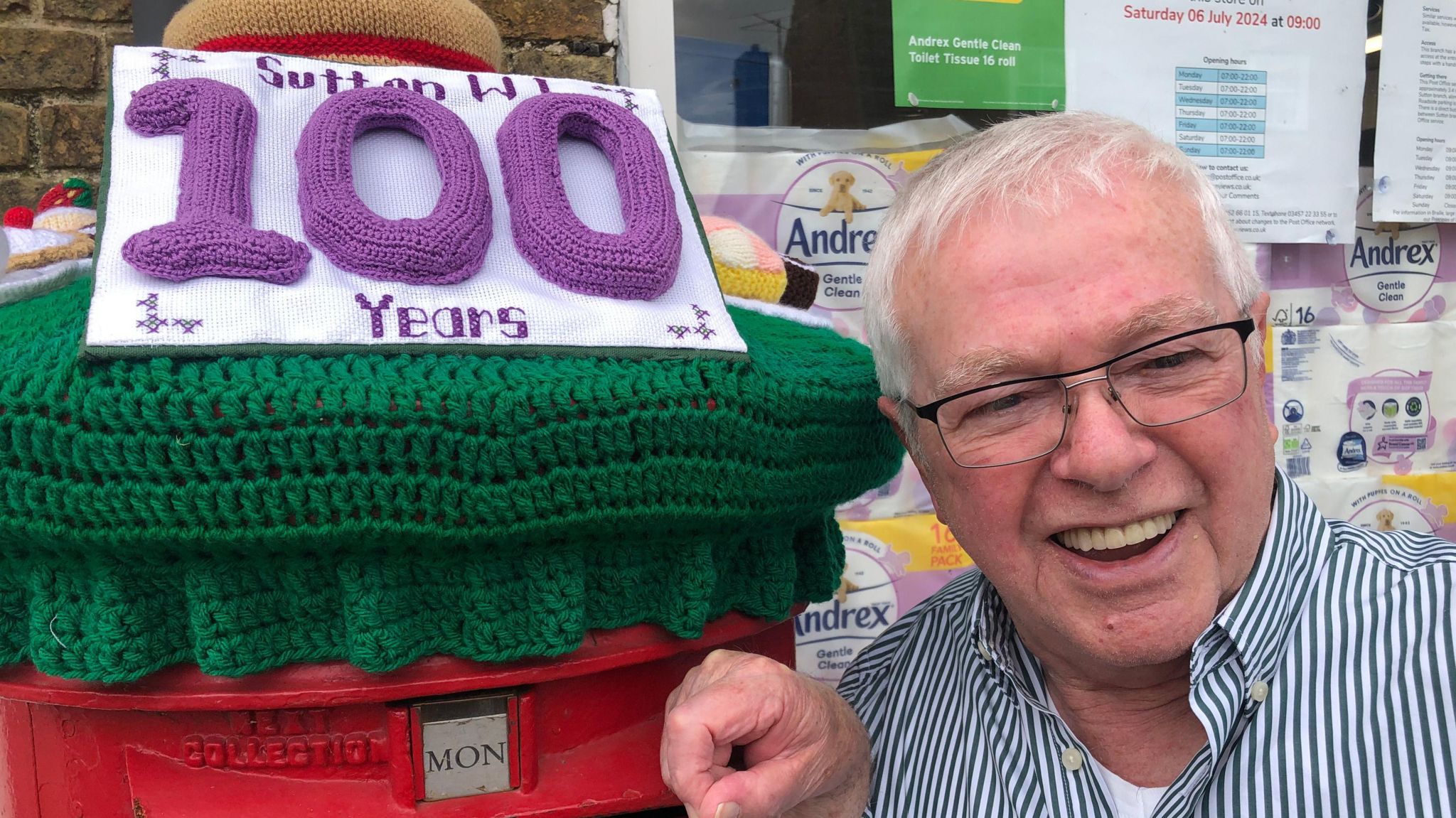 Dennis Roberts, 82, beside the colourful topper