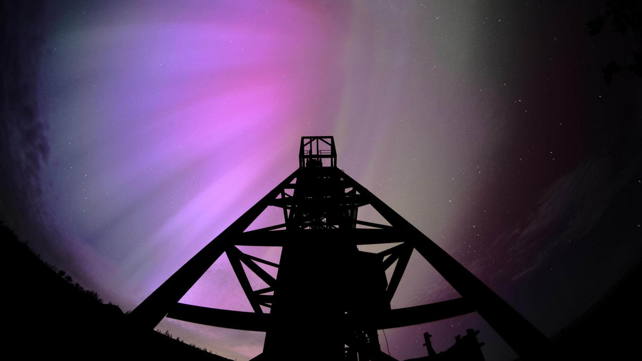 Purple lights above a dark tower
