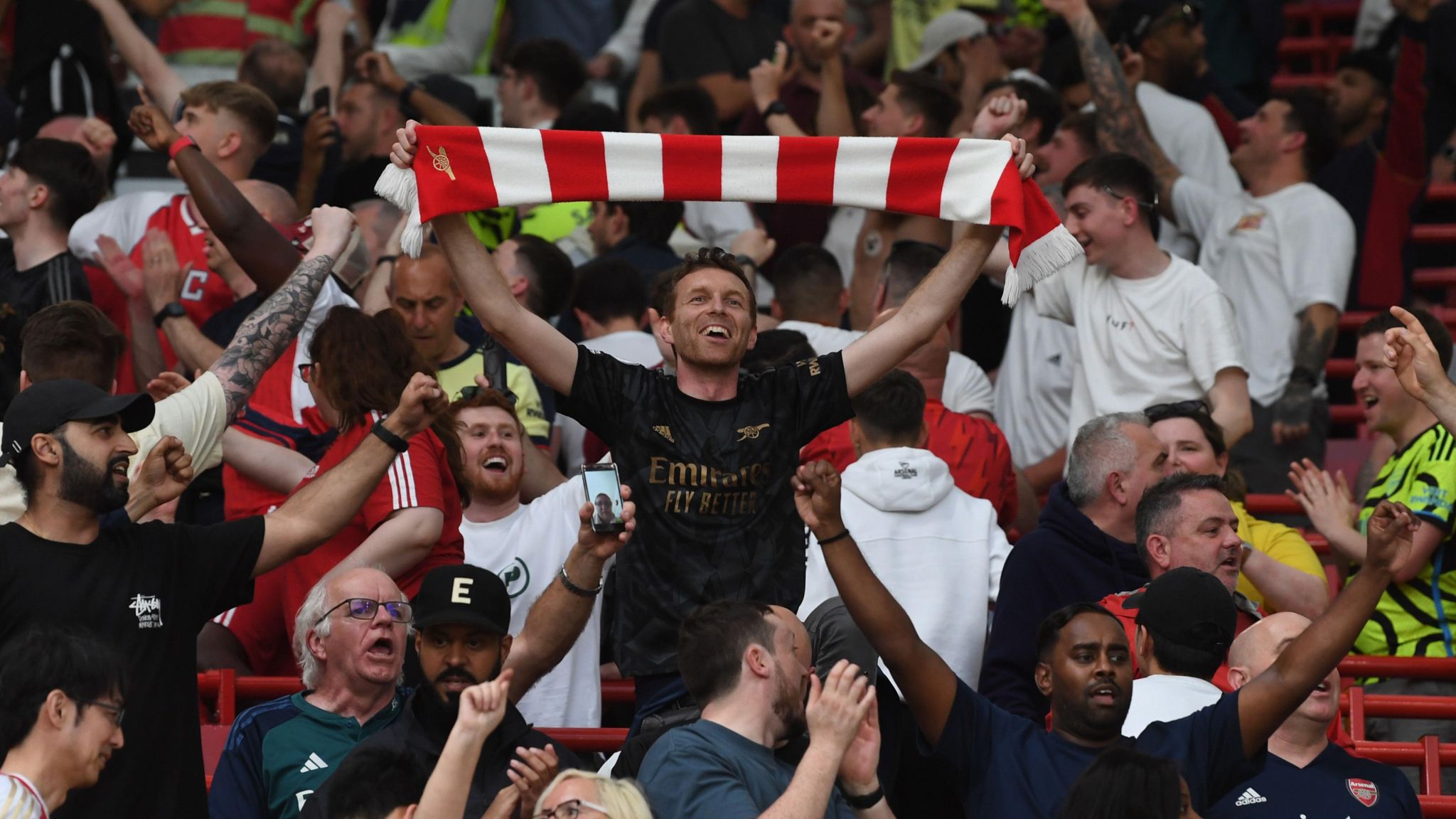 Arsenal fans celebrate their team's win at Manchester United