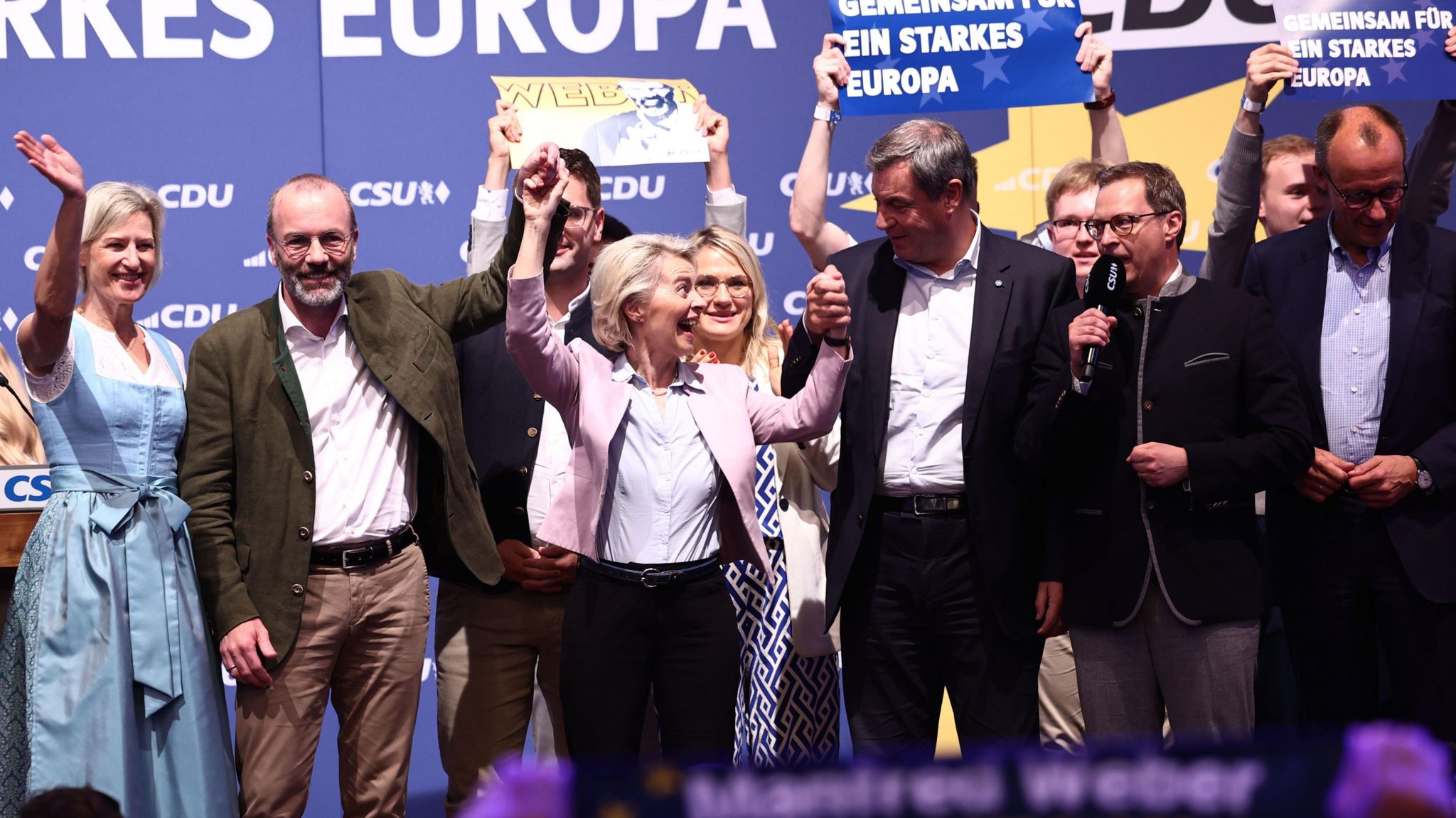 European Commision President Ursula von der Leyen (3-L) and Bavarian Premier Markus Soeder (C) hold hands, at the end of the final campaign rally of CDU and CSU for the European elections in Munich Germany, 07 June 2024.