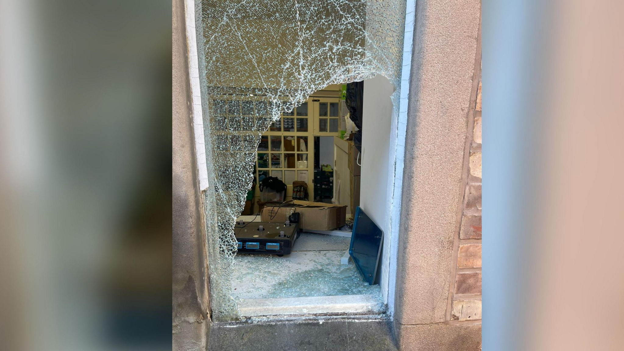 A smashed window at the food bank in Crumpsall