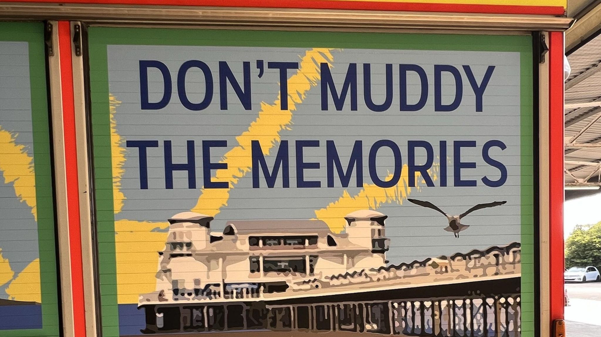 A mural on a fire engine, with an image of Weston's famous pier behind it and the phrase "Don't muddy the memories" 