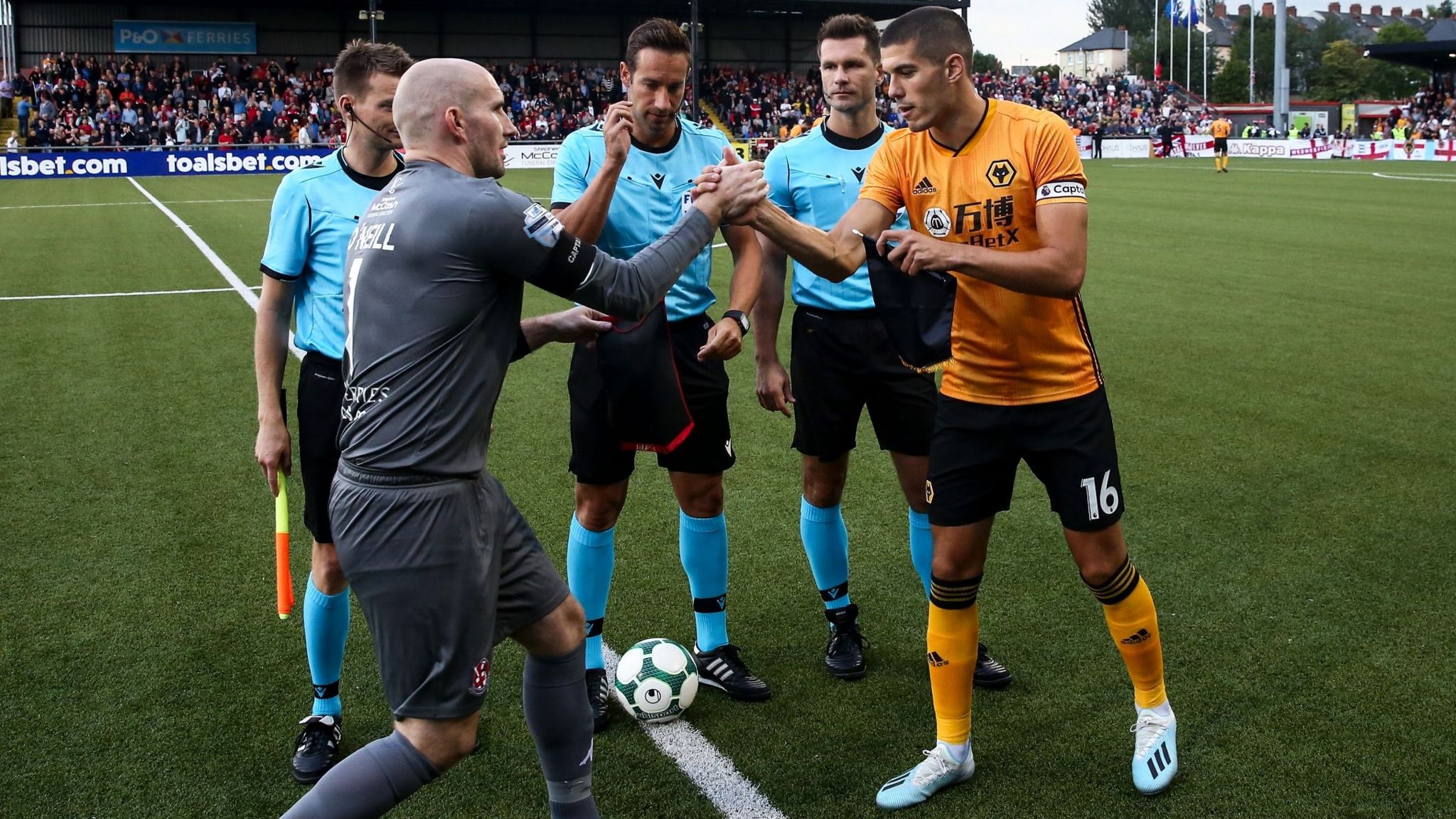 Crusaders captain Sean O'Neil shakes hands with Wolves captain Conor Coady