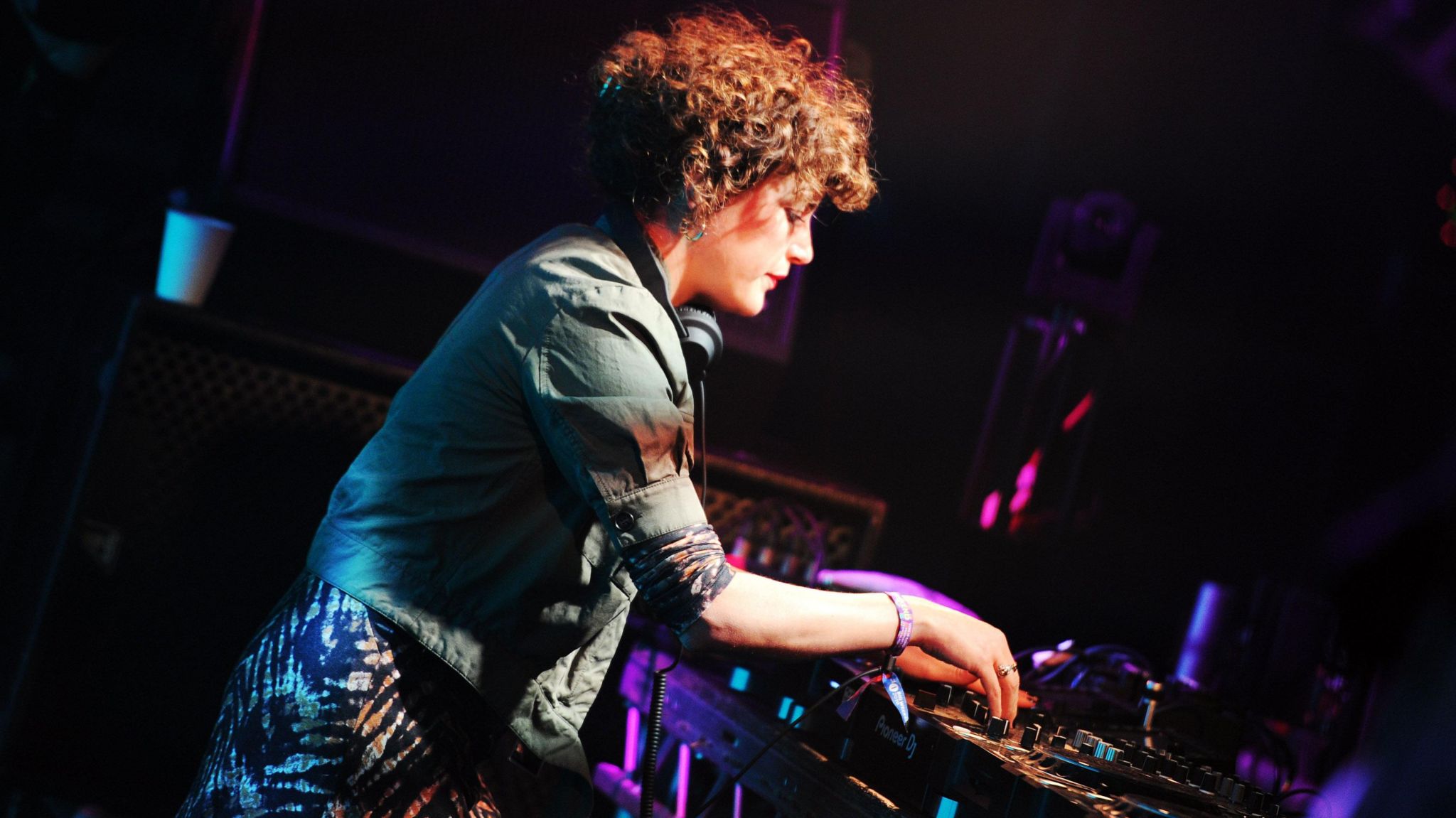 DJ Annie Mac performing. She is pictured standing at her decks.